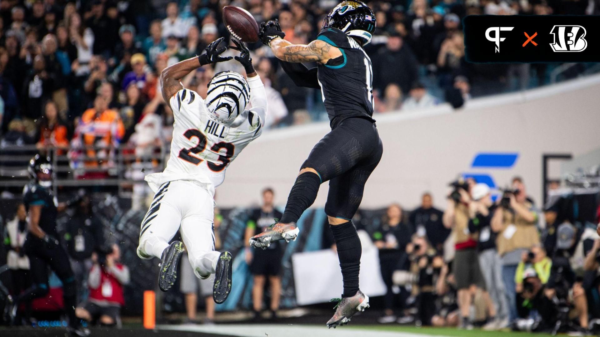 Jacksonville Jaguars wide receiver Parker Washington (11) makes the catch for a touchdown against Cincinnati Bengals safety Dax Hill (23) in the third quarter at EverBank Stadium.