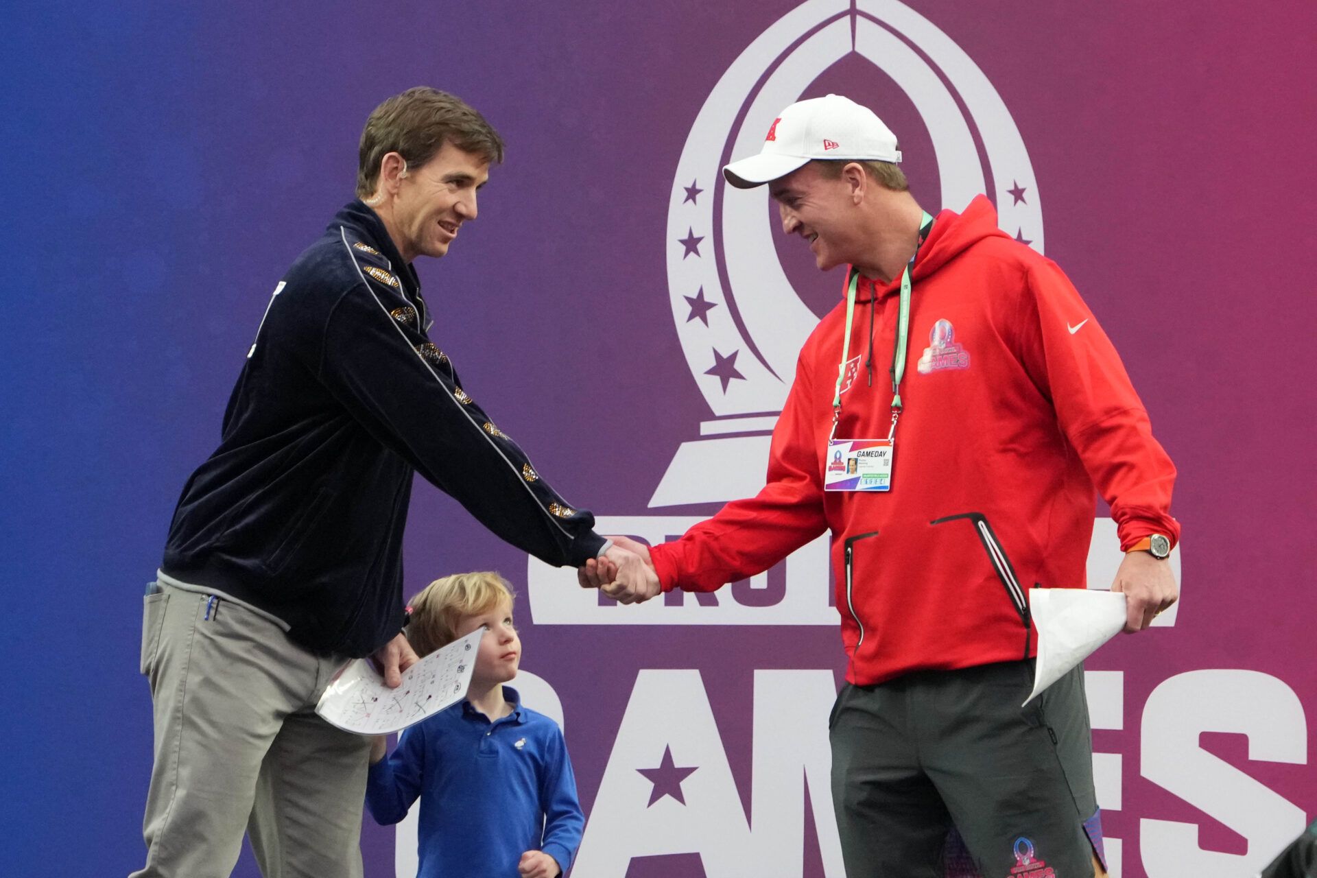 NFC captain Eli Manning (left) and AFC captain Peyton Manning shake hands during the Pro Bowl Games at Allegiant Stadium.