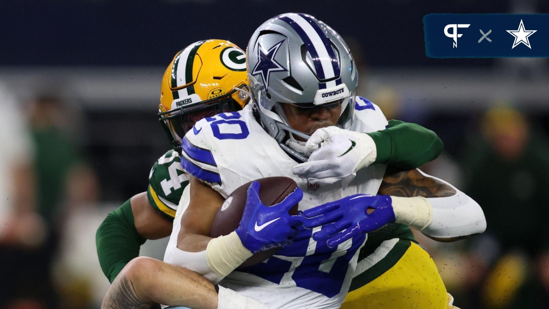 Dallas Cowboys running back Tony Pollard (20) rushes the ball against the Green Bay Packers during the first half for the 2024 NFC wild card game at AT&T Stadium.