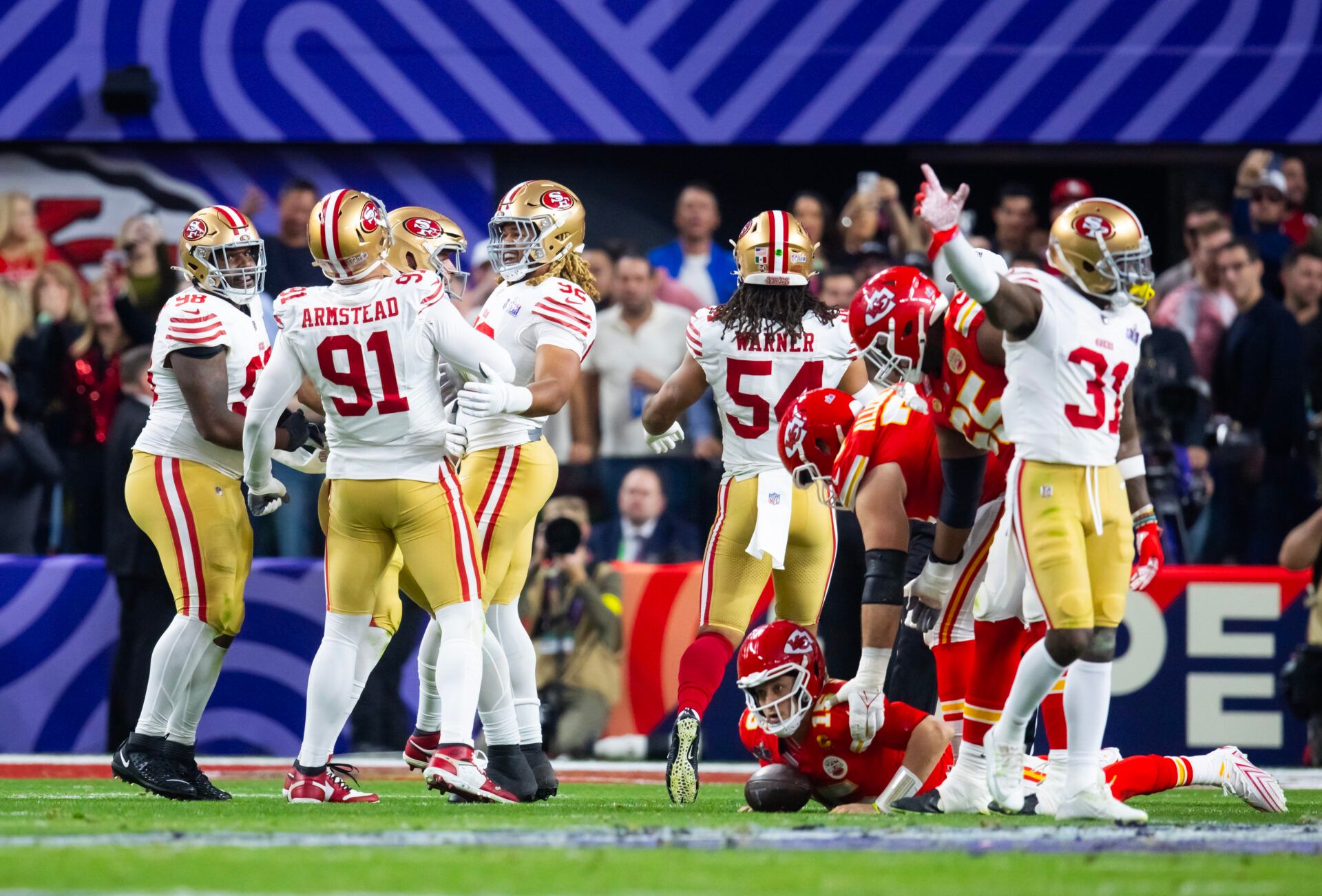 San Francisco 49ers defensive end Arik Armstead (91) celebrates with defensive end Chase Young (92) and defensive tackle Javon Hargrave (98) after sacking Kansas City Chiefs quarterback Patrick Mahomes (15) in Super Bowl LVIII at Allegiant Stadium.