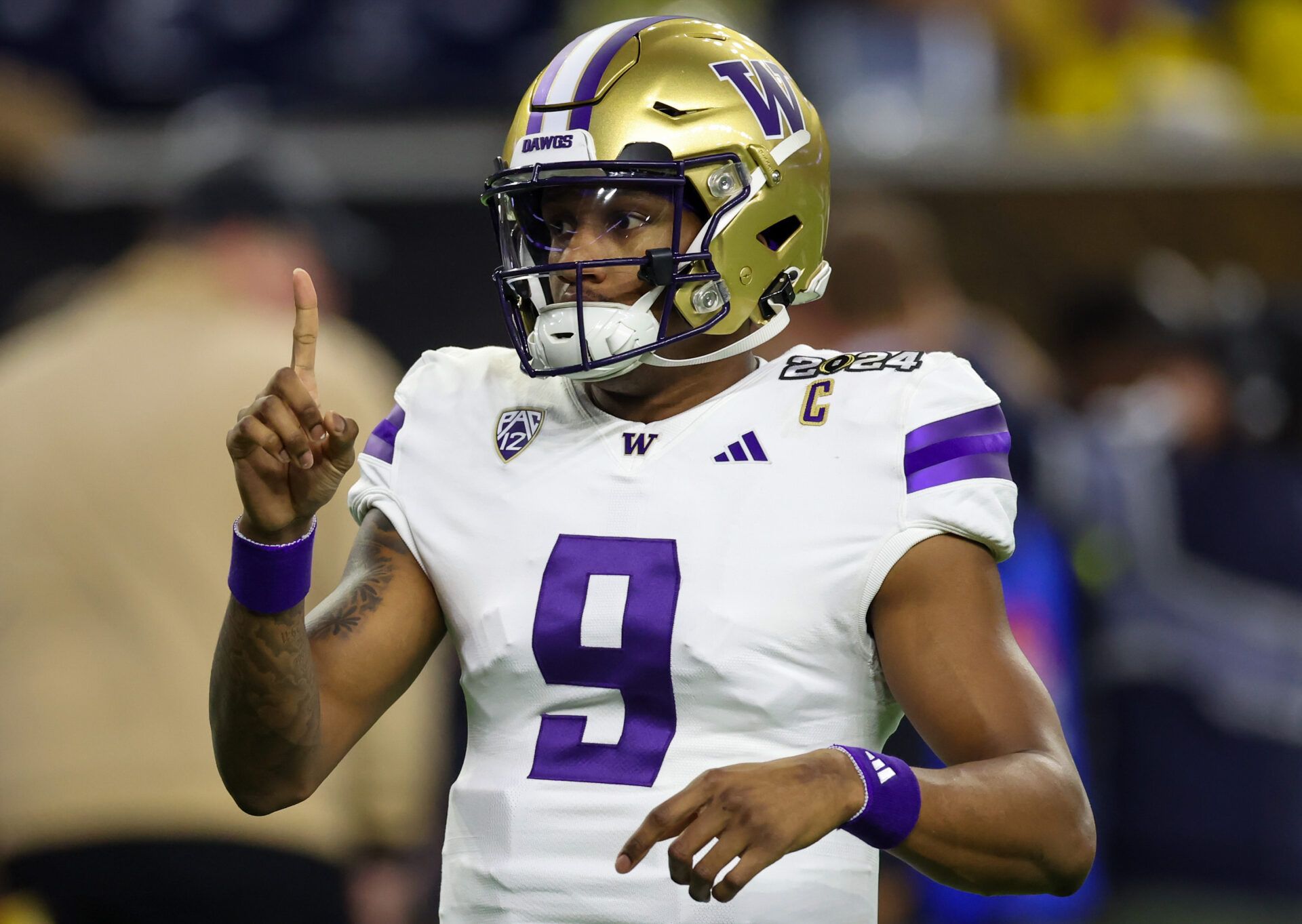 Washington Huskies quarterback Michael Penix Jr. (9) warms up before playing against the Michigan Wolverines in the 2024 College Football Playoff national championship game at NRG Stadium.