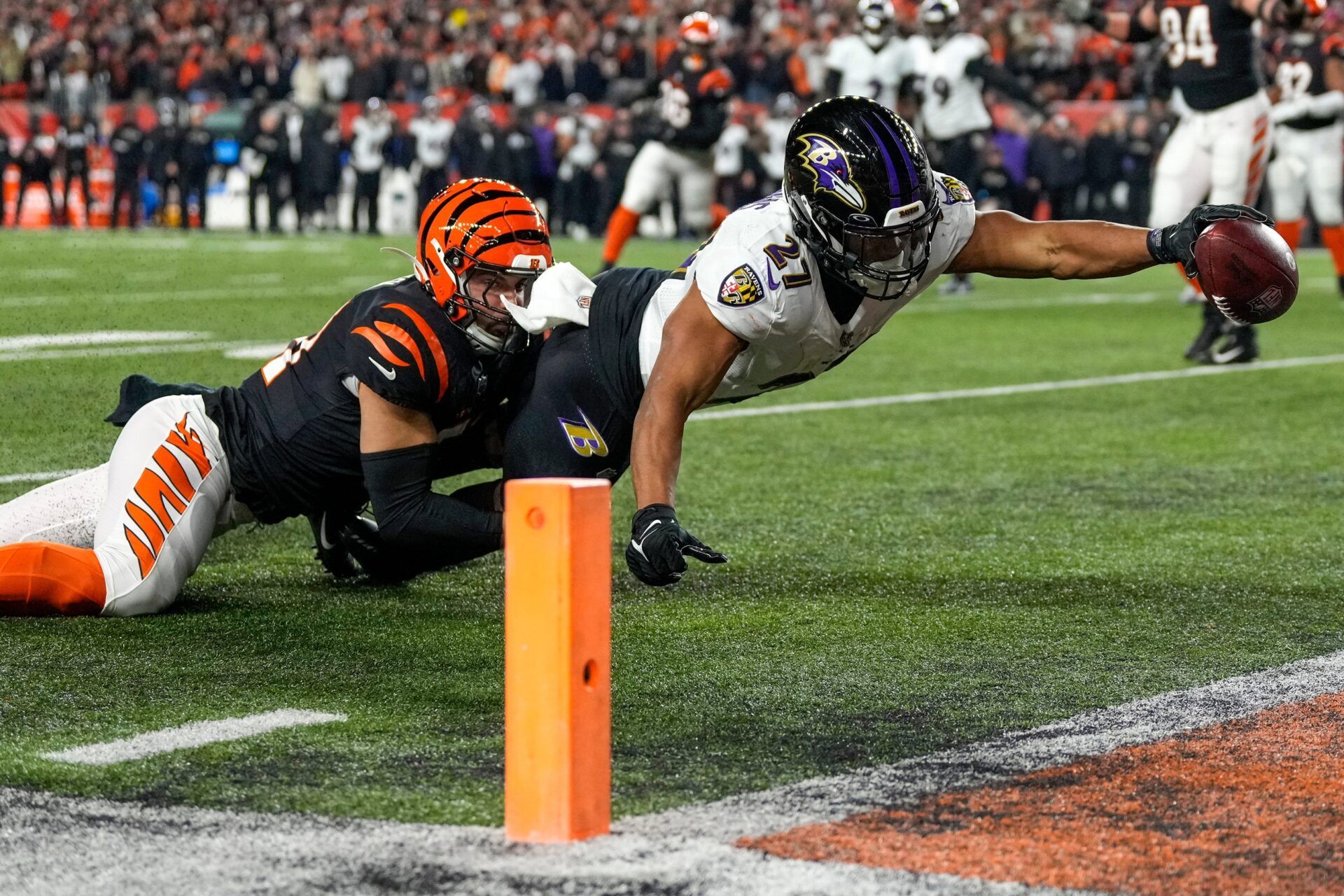 Baltimore Ravens running back J.K. Dobbins (27) breaks a tackle from Cincinnati Bengals linebacker Markus Bailey (51) stretches to break the plane for a touchdown in the second quarter during an NFL wild-card playoff football game between the Baltimore Ravens and the Cincinnati Bengals, Sunday, Jan. 15, 2023, at Paycor Stadium in Cincinnati.The Ravens led 10-9 at halftime.