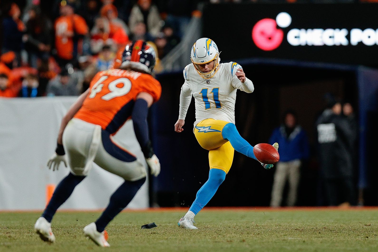 Los Angeles Chargers kicker Cameron Dicker (11) attempts an onside kick against the Denver Broncos.