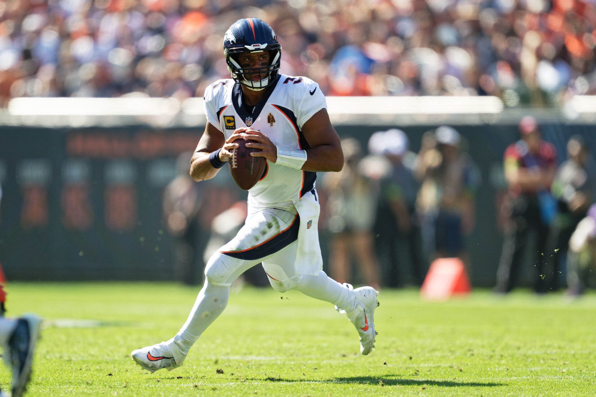 Denver Broncos quarterback Russell Wilson (3) runs with the ball against the Chicago Bears at Soldier Field.