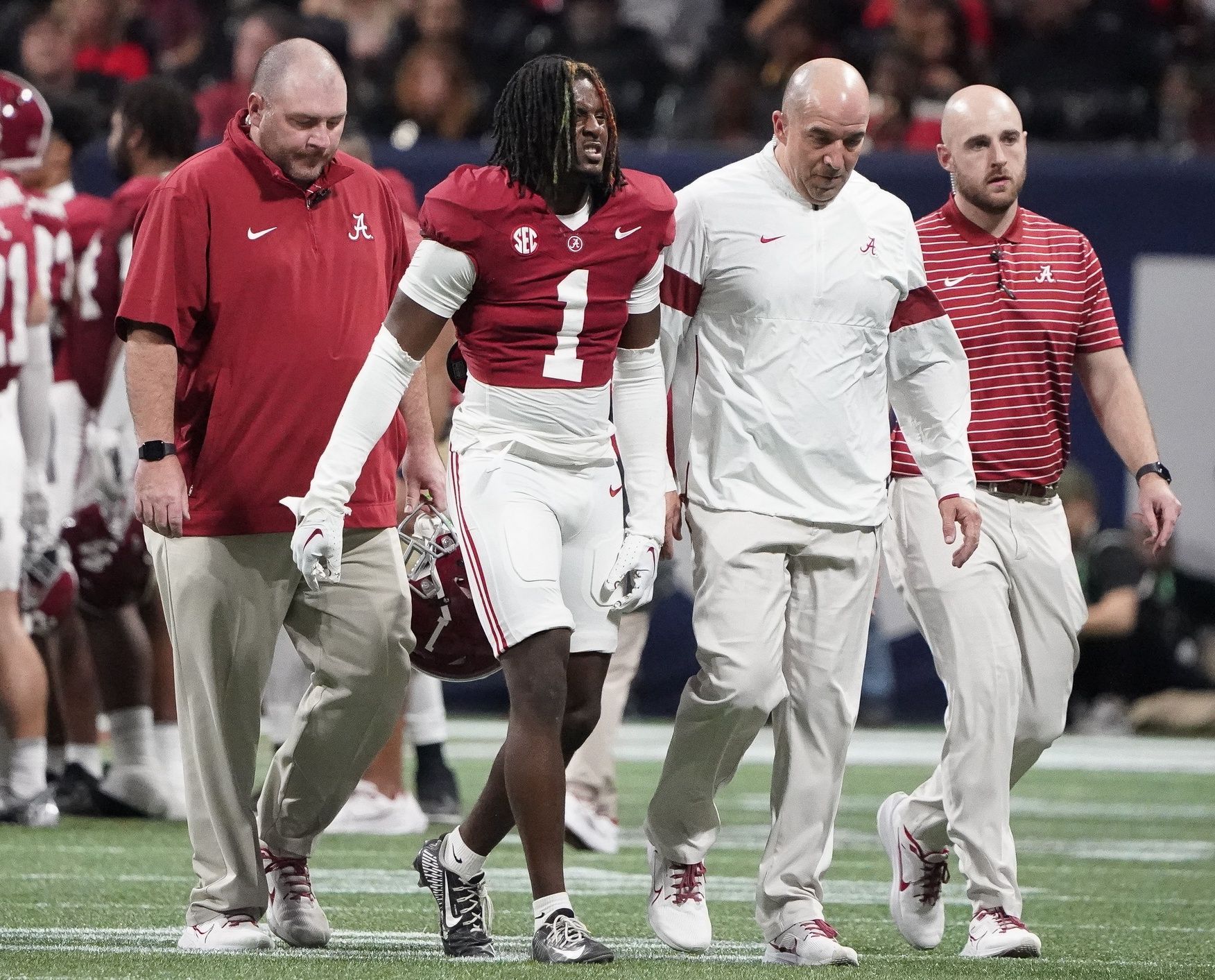 Alabama Crimson Tide defensive back Kool-Aid McKinstry (1) leaves the field with trainers after being injured at Mercedes-Benz Stadium. Alabama defeated Georgia 27-24 to claim the SEC Championship.