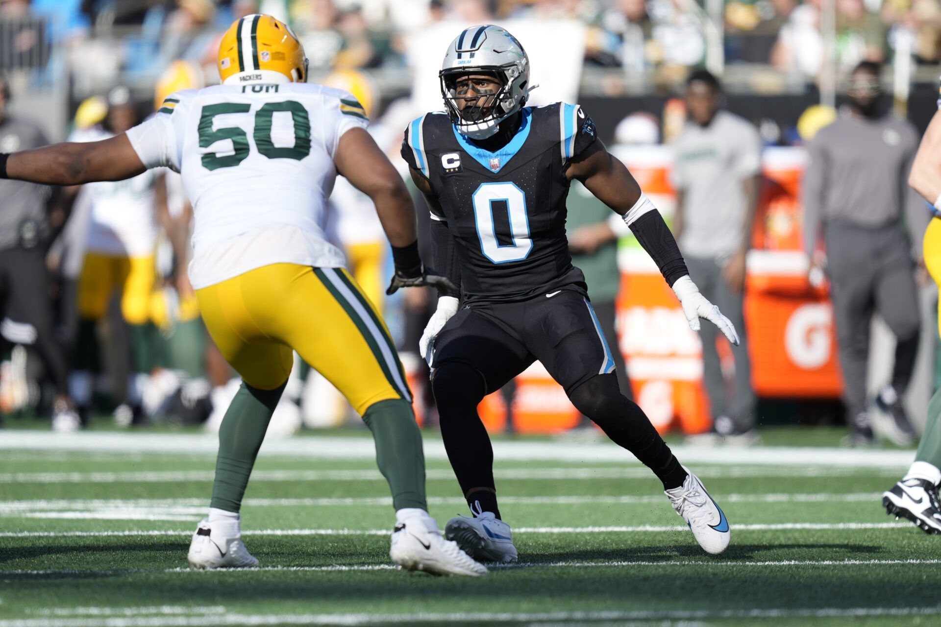 Carolina Panthers linebacker Brian Burns (0) on the edge against Green Bay Packers guard Zach Tom (50).