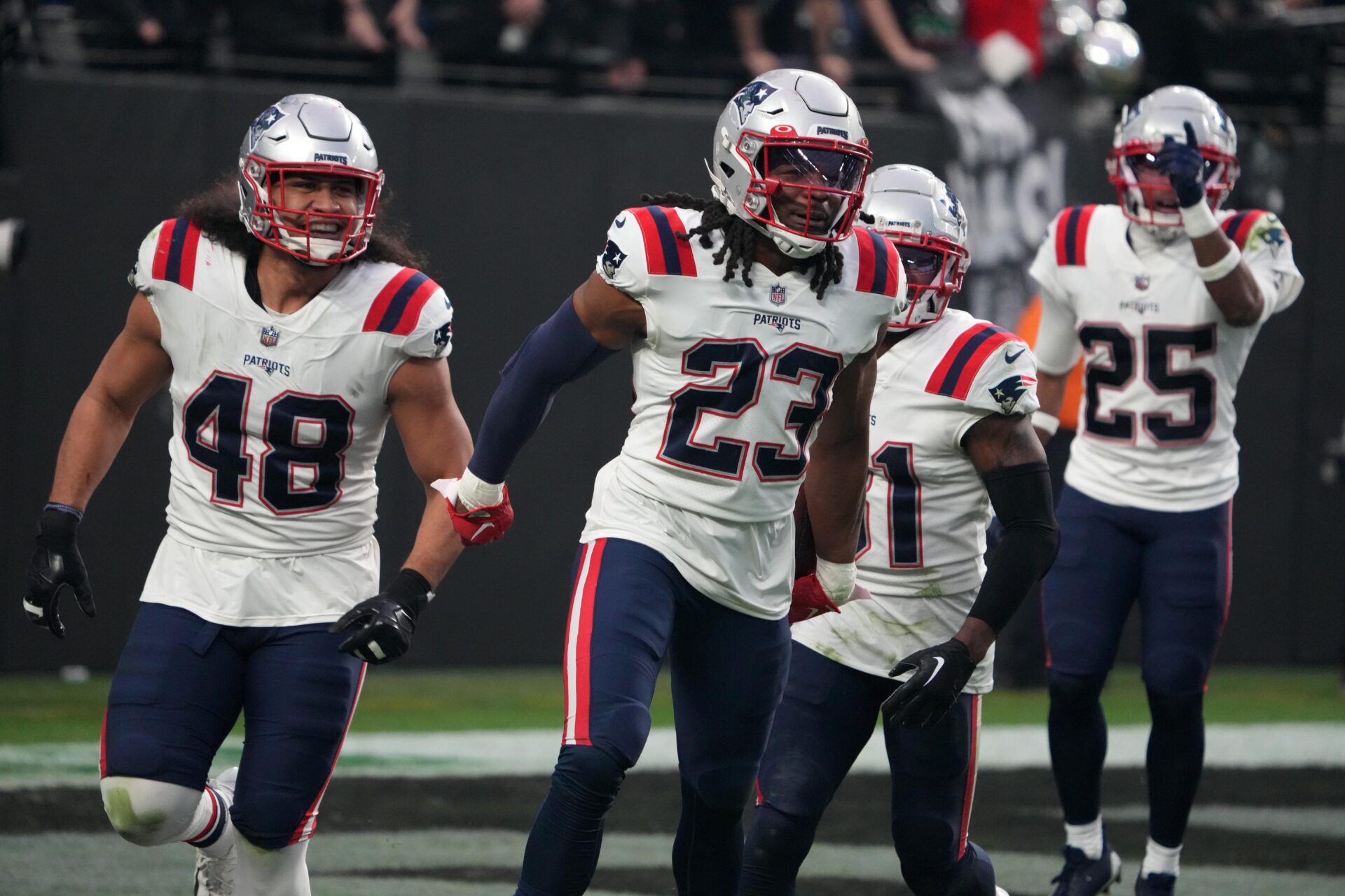 New England Patriots safety Kyle Dugger (23) celebrates with linebacker Jahlani Tavai (48) after scoring on an 18-yard interception return against the Las Vegas Raiders in the third quarter at Allegiant Stadium.