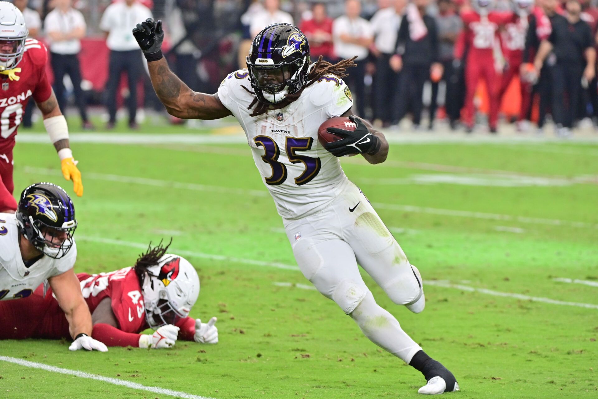 Baltimore Ravens running back Gus Edwards (35) runs for a touchdown in the second half against the Arizona Cardinals at State Farm Stadium.