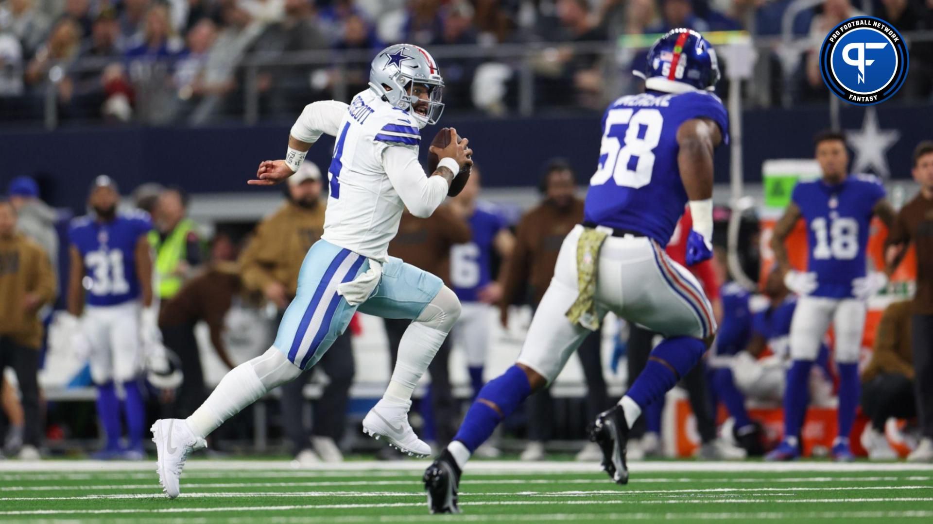 Dallas Cowboys quarterback Dak Prescott (4) runs with the ball as New York Giants linebacker Bobby Okereke (58) defends during the first quarter at AT&T Stadium.