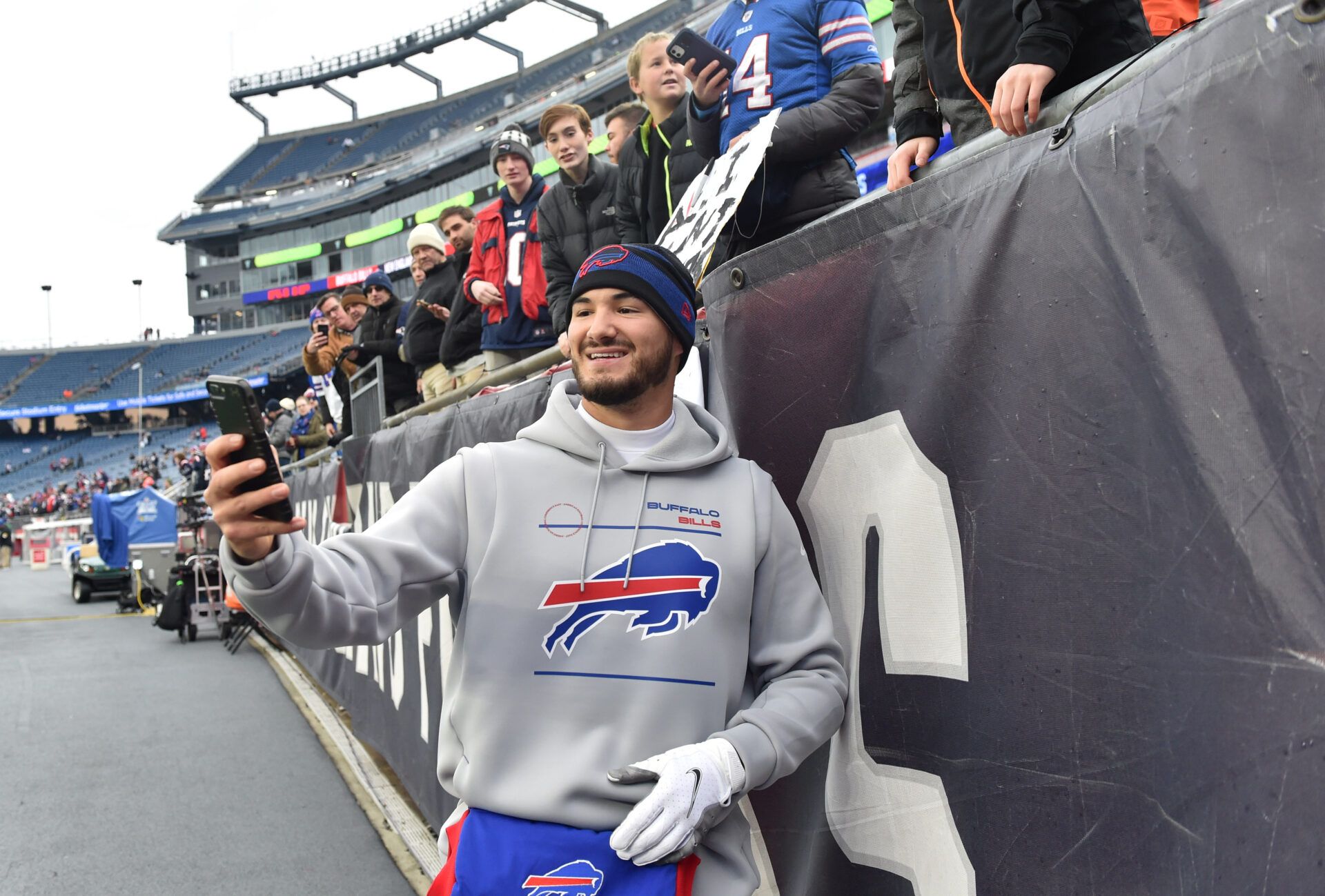 Buffalo Bills quarterback Mitchell Trubisky (10) takes a selfie with a fan prior to a game against the New England Patriots at Gillette Stadium.