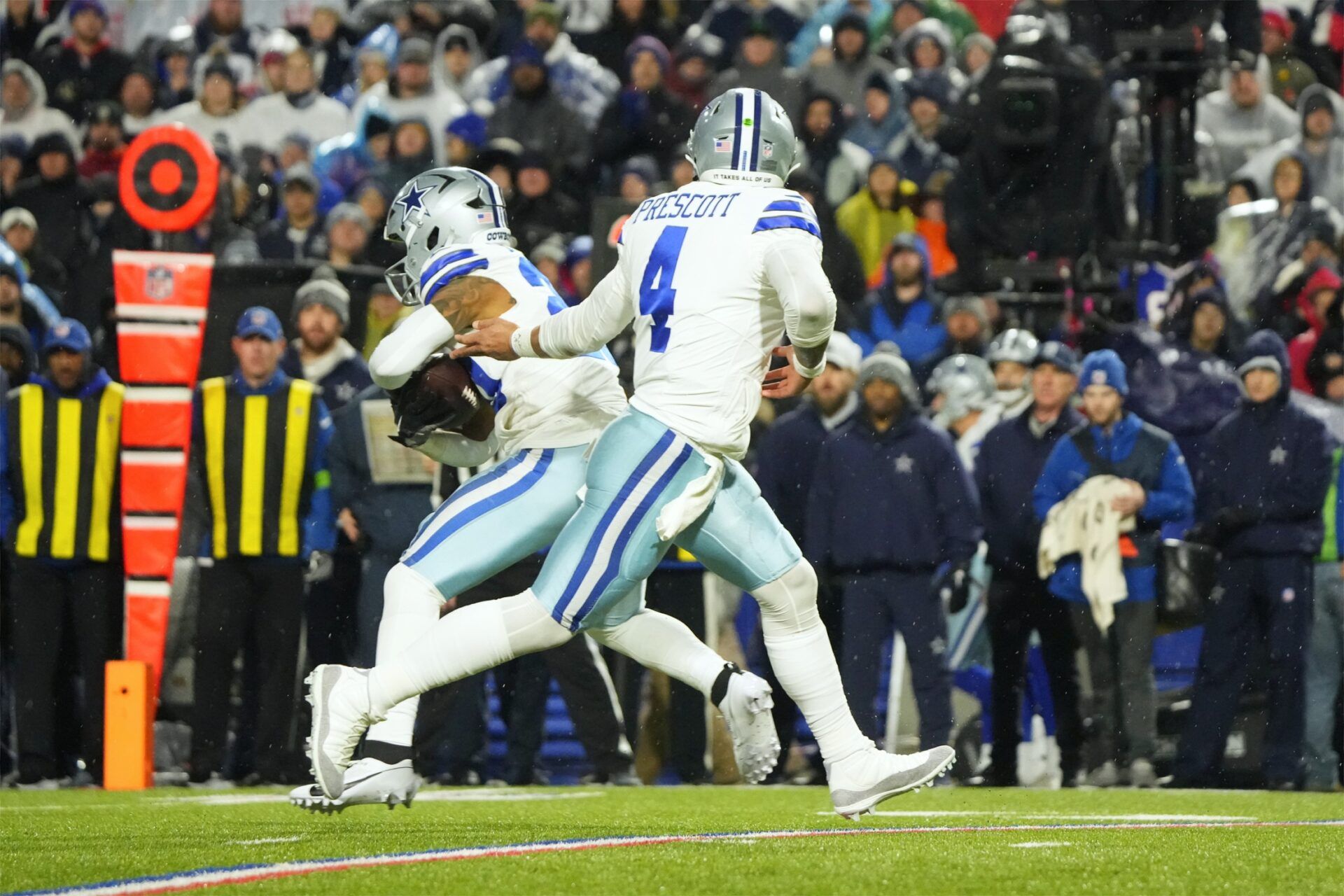 Dallas Cowboys quarterback Dak Prescott (4) hands the ball off to Dallas Cowboys running back Tony Pollard (20) in the second half at Highmark Stadium.