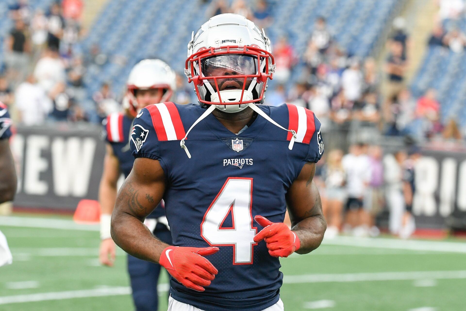 Aug 11, 2022; Foxborough, Massachusetts, USA; New England Patriots cornerback Malcolm Butler (4) warms up before a preseason game against the New York Giants at Gillette Stadium. Mandatory Credit: Eric Canha-USA TODAY Sports