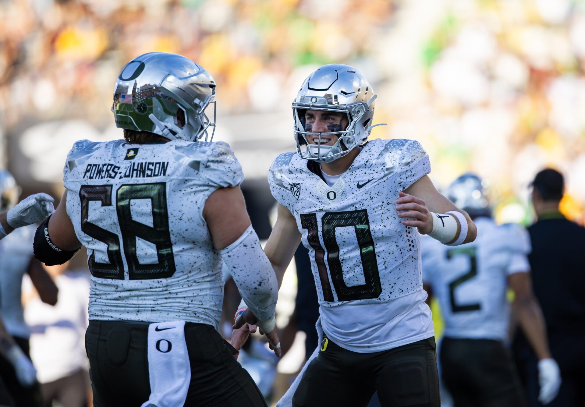 Oregon Ducks quarterback Bo Nix (10) celebrates a touchdown with offensive lineman Jackson Powers-Johnson (58) against the Arizona State Sun Devils in the first half at Mountain America Stadium.