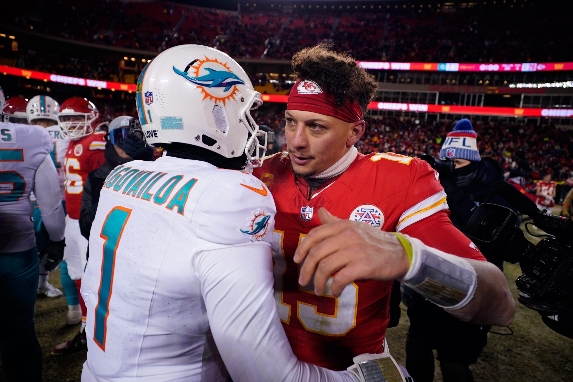 Kansas City Chiefs quarterback Patrick Mahomes (15) meets with Miami Dolphins quarterback Tua Tagovailoa (1) following the 2024 AFC wild card game at GEHA Field at Arrowhead Stadium.