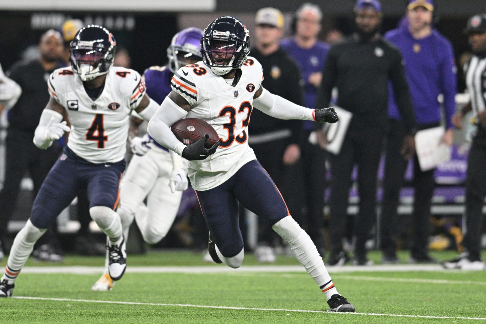 Chicago Bears cornerback Jaylon Johnson (33) returns an interception as safety Eddie Jackson (4) looks on against the Minnesota Vikings during the second quarter at U.S. Bank Stadium.