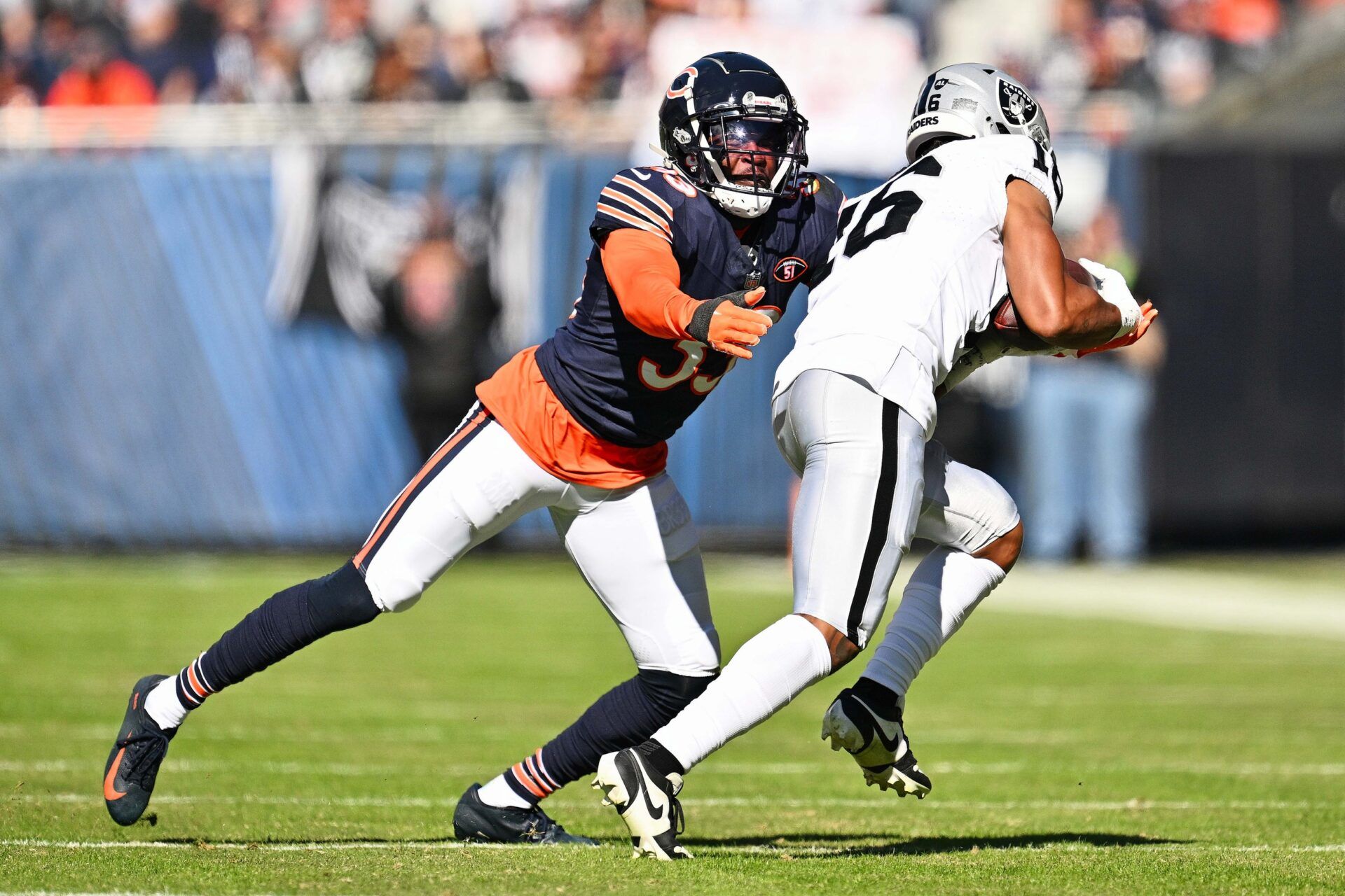 Chicago Bears defensive back Jaylon Johnson (33) tackles Las Vegas Raiders wide receiver Jakobi Meyers (16) at Soldier Field.