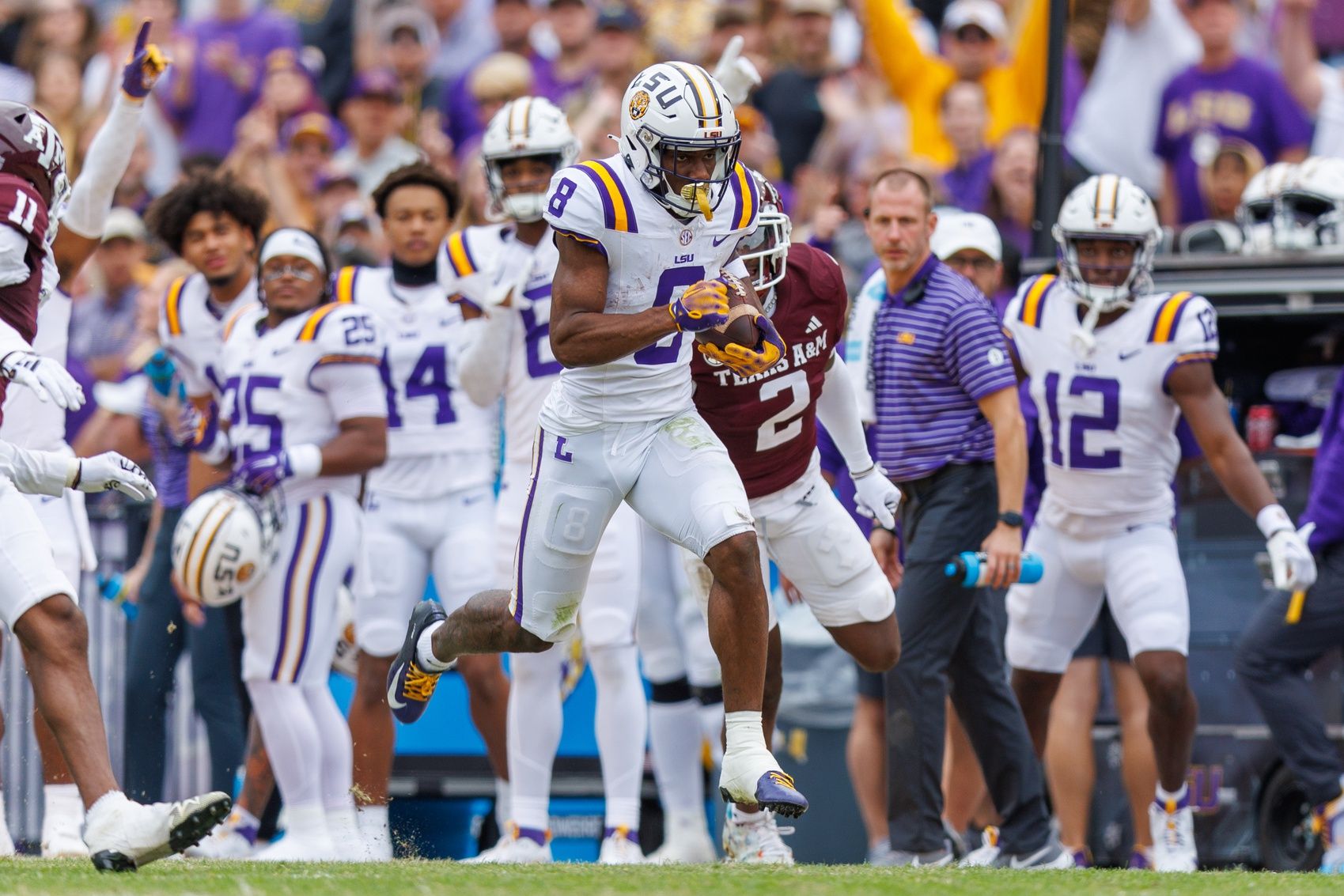 LSU Tigers wide receiver Malik Nabers (8) runs against Texas A&M Aggies defensive back Jacoby Mathews (2) during the second half at Tiger Stadium.