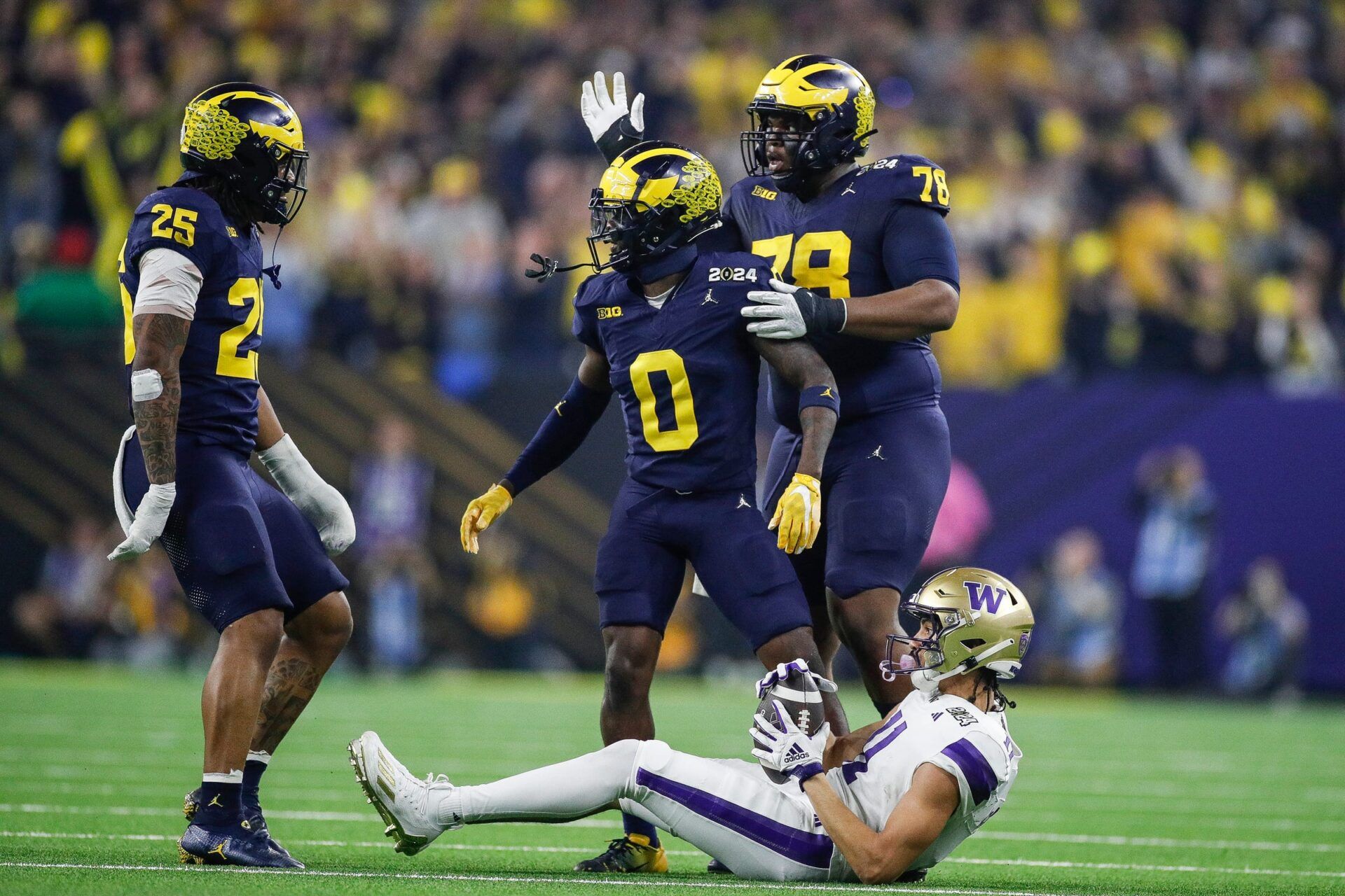 Michigan defensive back Mike Sainristil celebrates a play against Washington during the first half of the national championship game at NRG Stadium in Houston, Texas on Monday, Jan. 8, 2024.