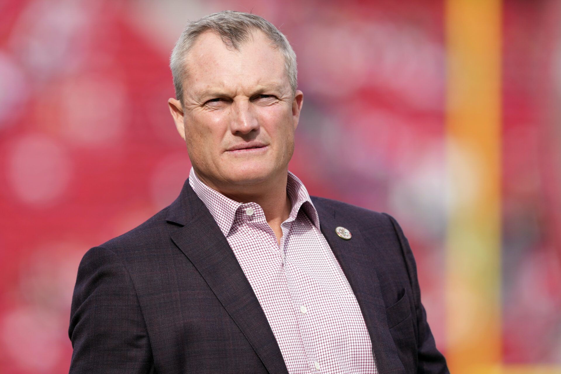 San Francisco 49ers general manager John Lynch stands on the field before the game against the Seattle Seahawks at Levi's Stadium.