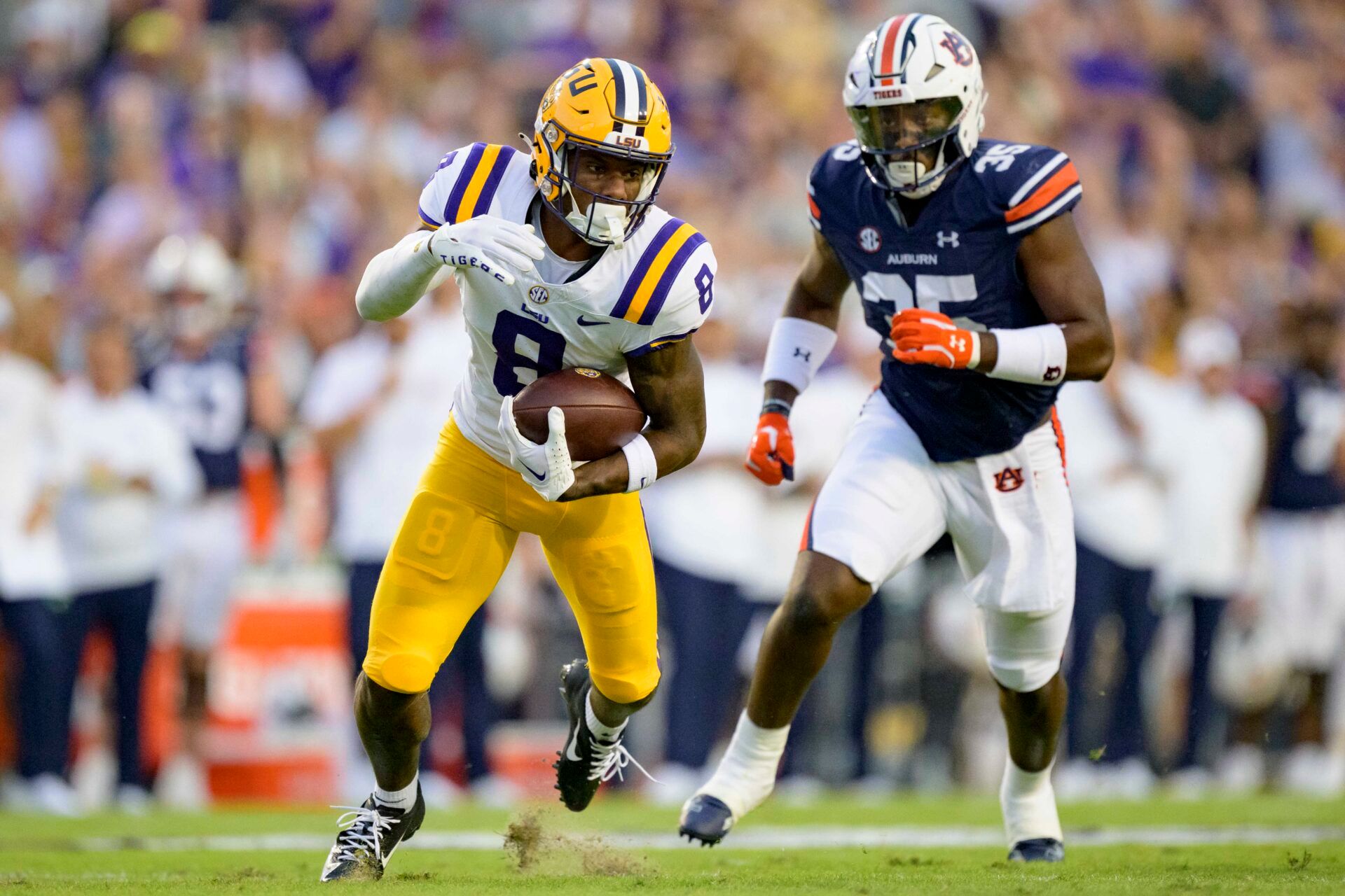 LSU Tigers wide receiver Malik Nabers (8) makes a run after a reception against Auburn Tigers linebacker Jalen McLeod (35) during the first quarter at Tiger Stadium.