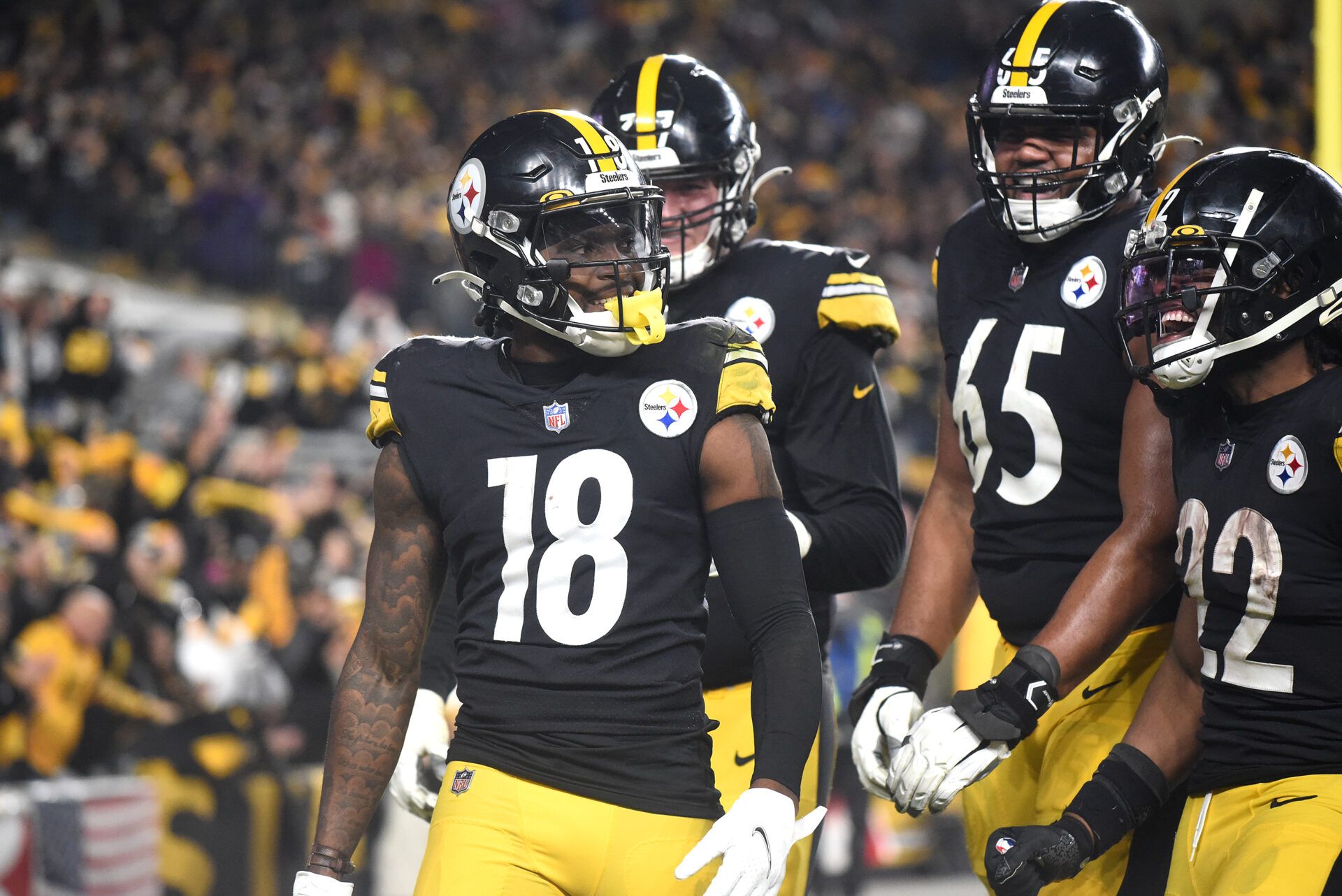 Pittsburgh Steelers wide receiver Diontae Johnson (18) celebrates a touchdown during the fourth quarter with offensive lineman John Leglue (77) and Dan Moore Jr. (65) and Najee Harris (22) against the Baltimore Ravens at Heinz Field.