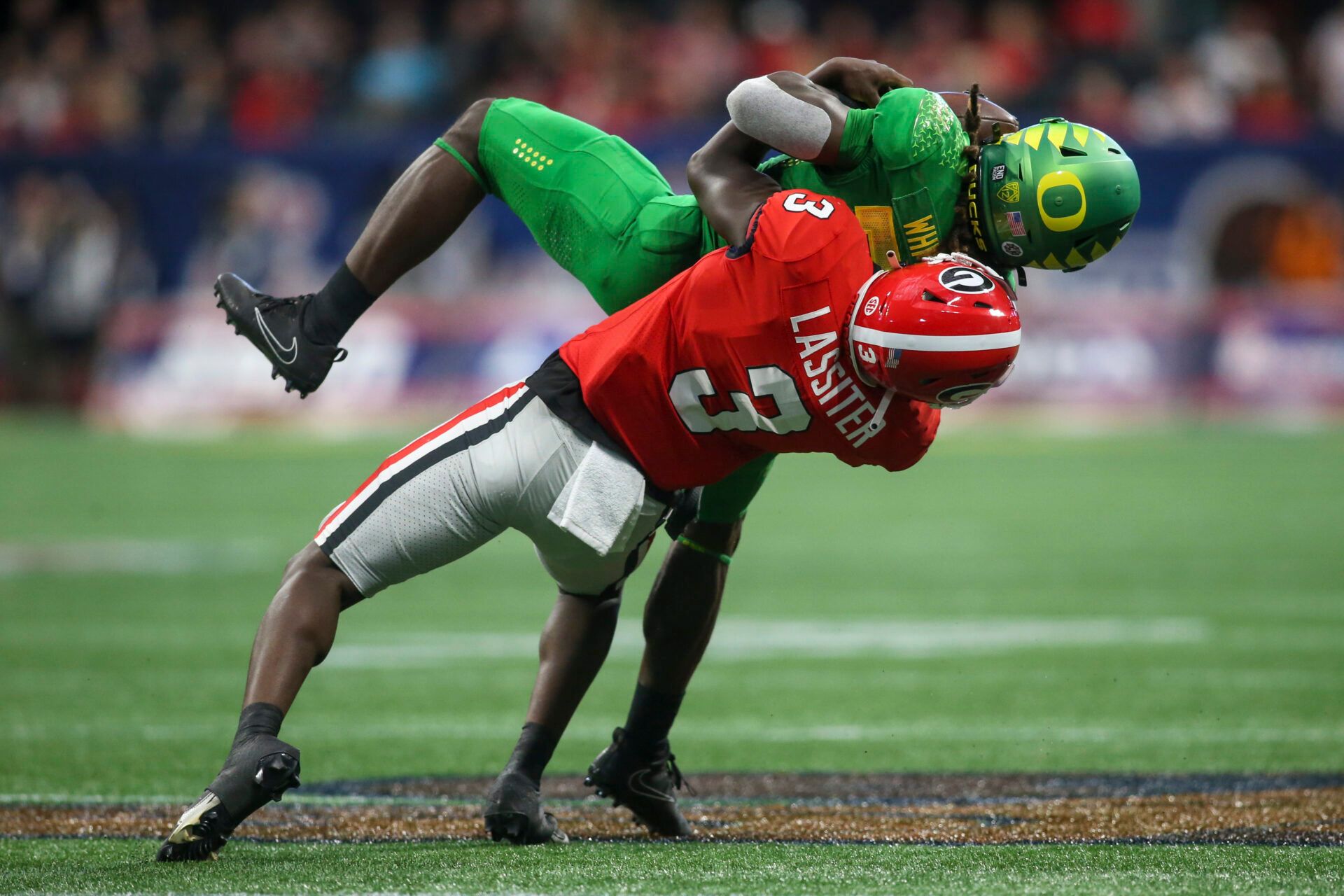 Georgia Bulldogs defensive back Kamari Lassiter (3) tackles Oregon Ducks running back Noah Whittington (22) in the second quarter at Mercedes-Benz Stadium.