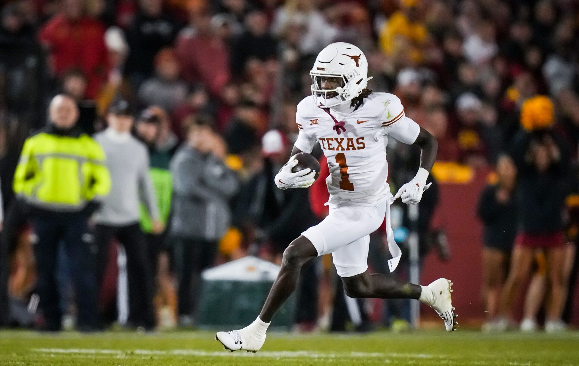 Texas Longhorns wide receiver Xavier Worthy (1) carries the ball in the first half of the Longhorns' game against the Iowa State Cyclones at Jack Trice Stadium.