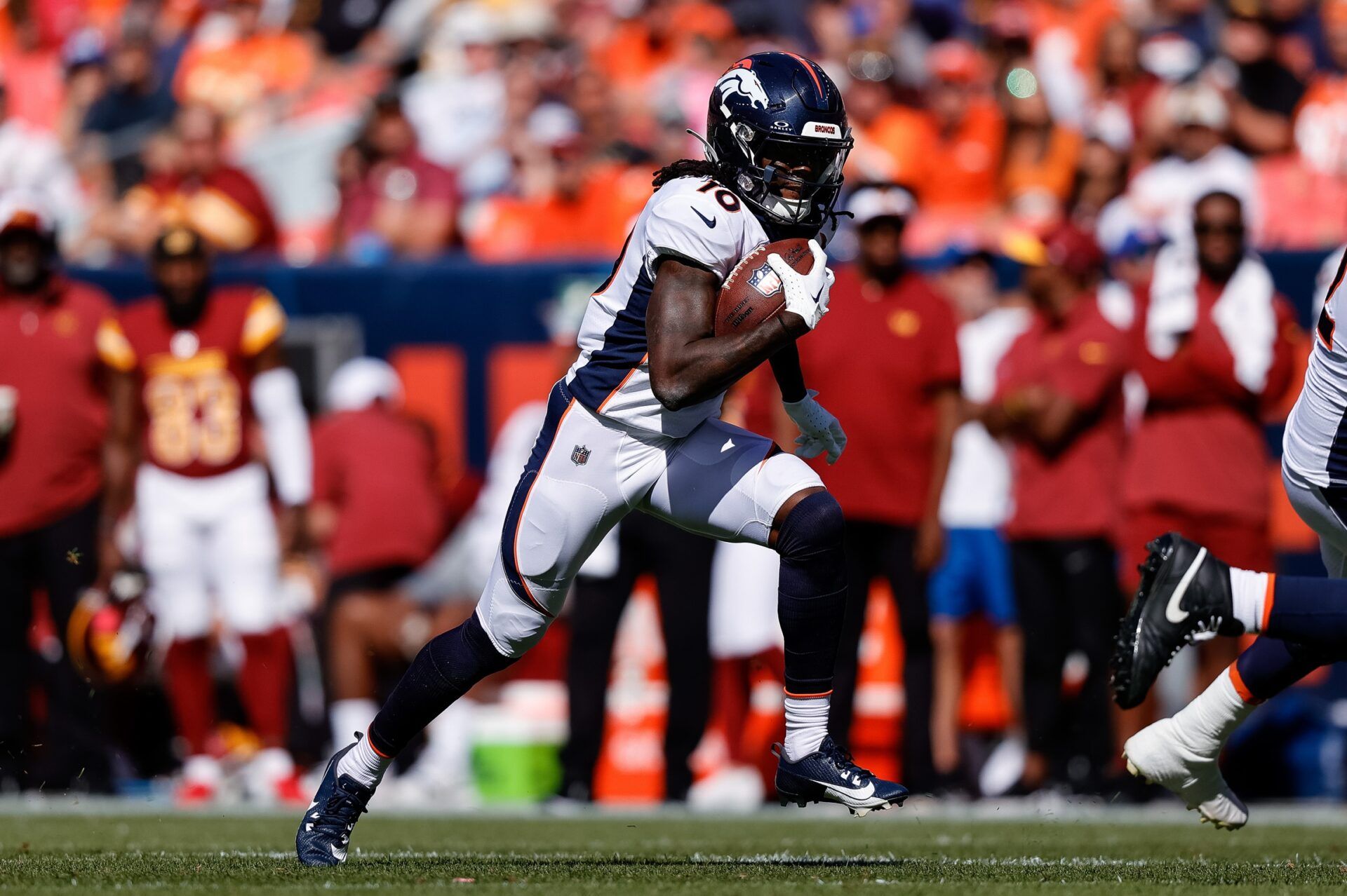 Denver Broncos wide receiver Jerry Jeudy (10) runs the ball on a reception in the second quarter against the Washington Commanders at Empower Field at Mile High.