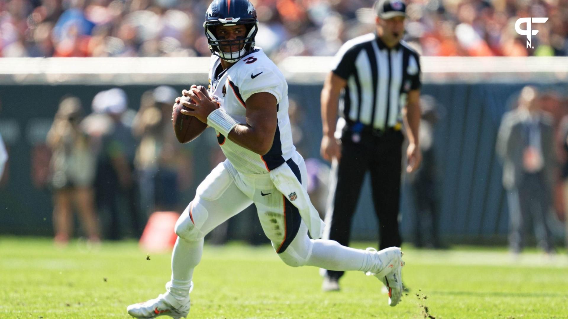 Denver Broncos quarterback Russell Wilson (3) runs with the ball against the Chicago Bears at Soldier Field.