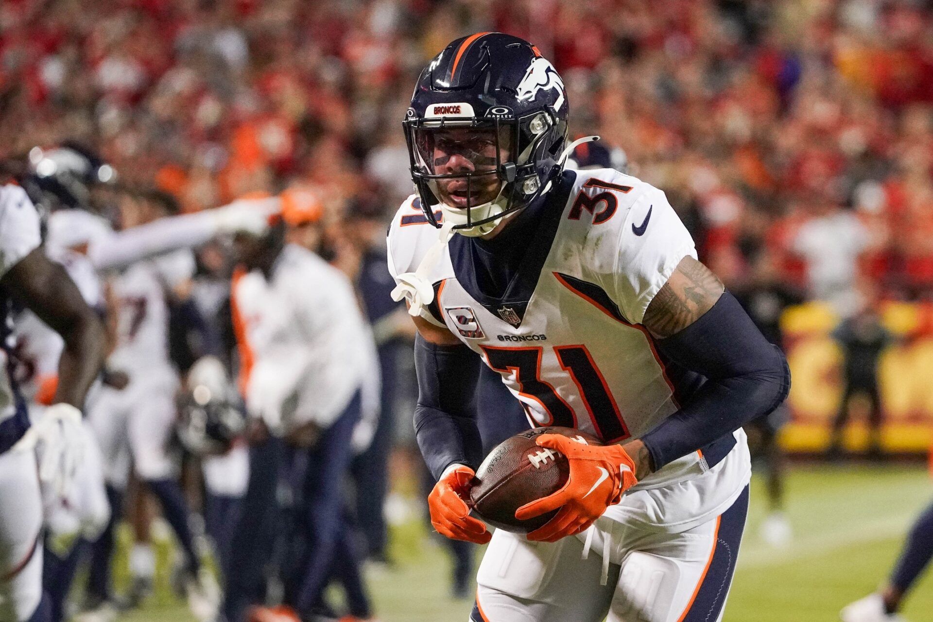 Denver Broncos safety Justin Simmons (31) runs the ball against the Kansas City Chiefs during the game at GEHA Field at Arrowhead Stadium.