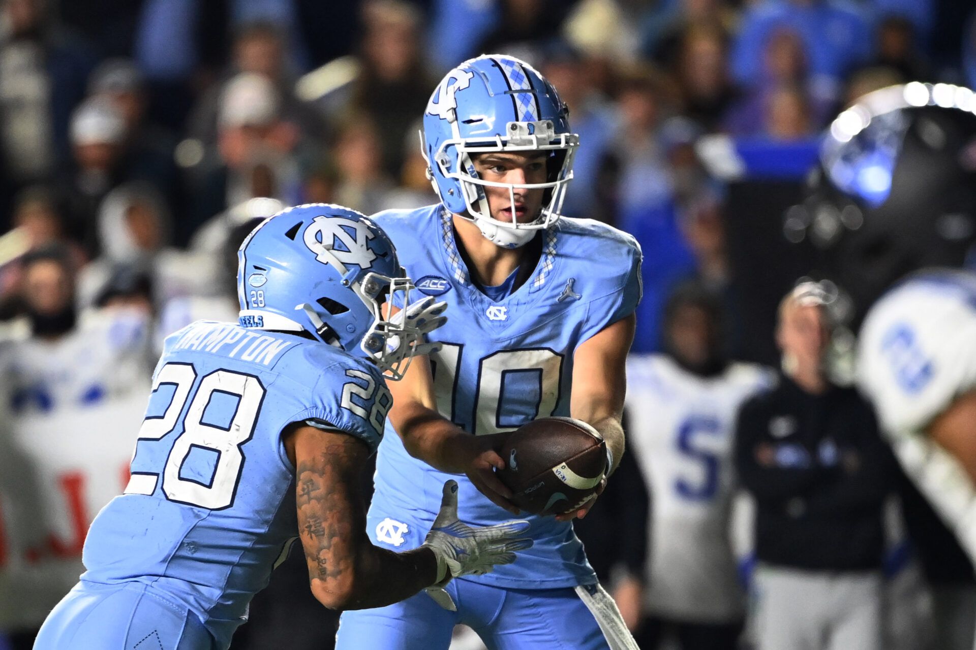 Nov 11, 2023; Chapel Hill, North Carolina, USA; North Carolina Tar Heels quarterback Drake Maye (10) hands the ball off to running back Omarion Hampton (28) in the fourth quarter at Kenan Memorial Stadium. Mandatory Credit: Bob Donnan-USA TODAY Sports