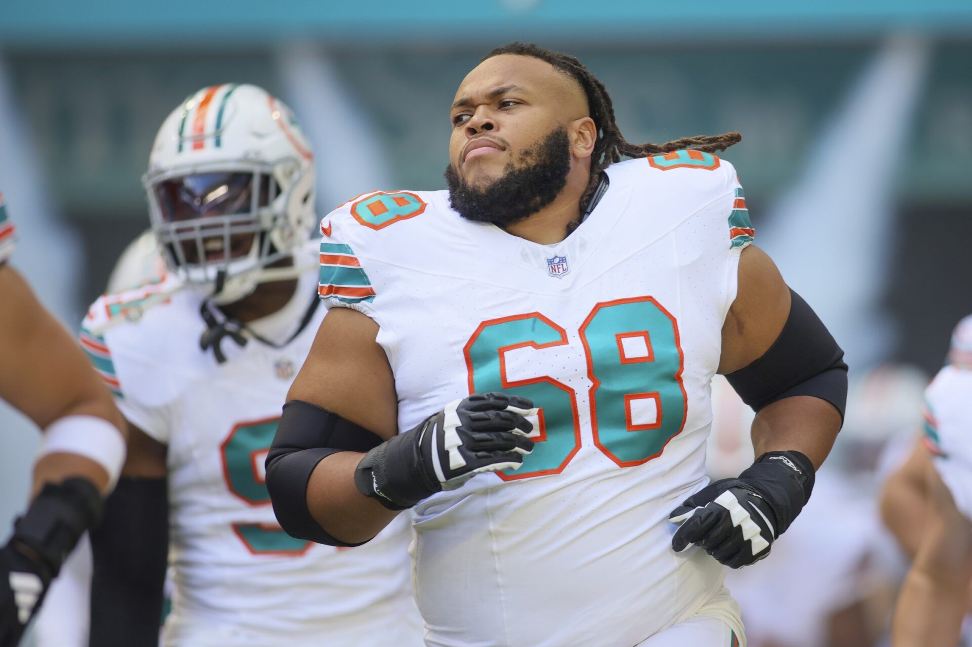 Miami Dolphins offensive tackle Robert Hunt (68) runs on the field prior to the game against the New England Patriots at Hard Rock Stadium.