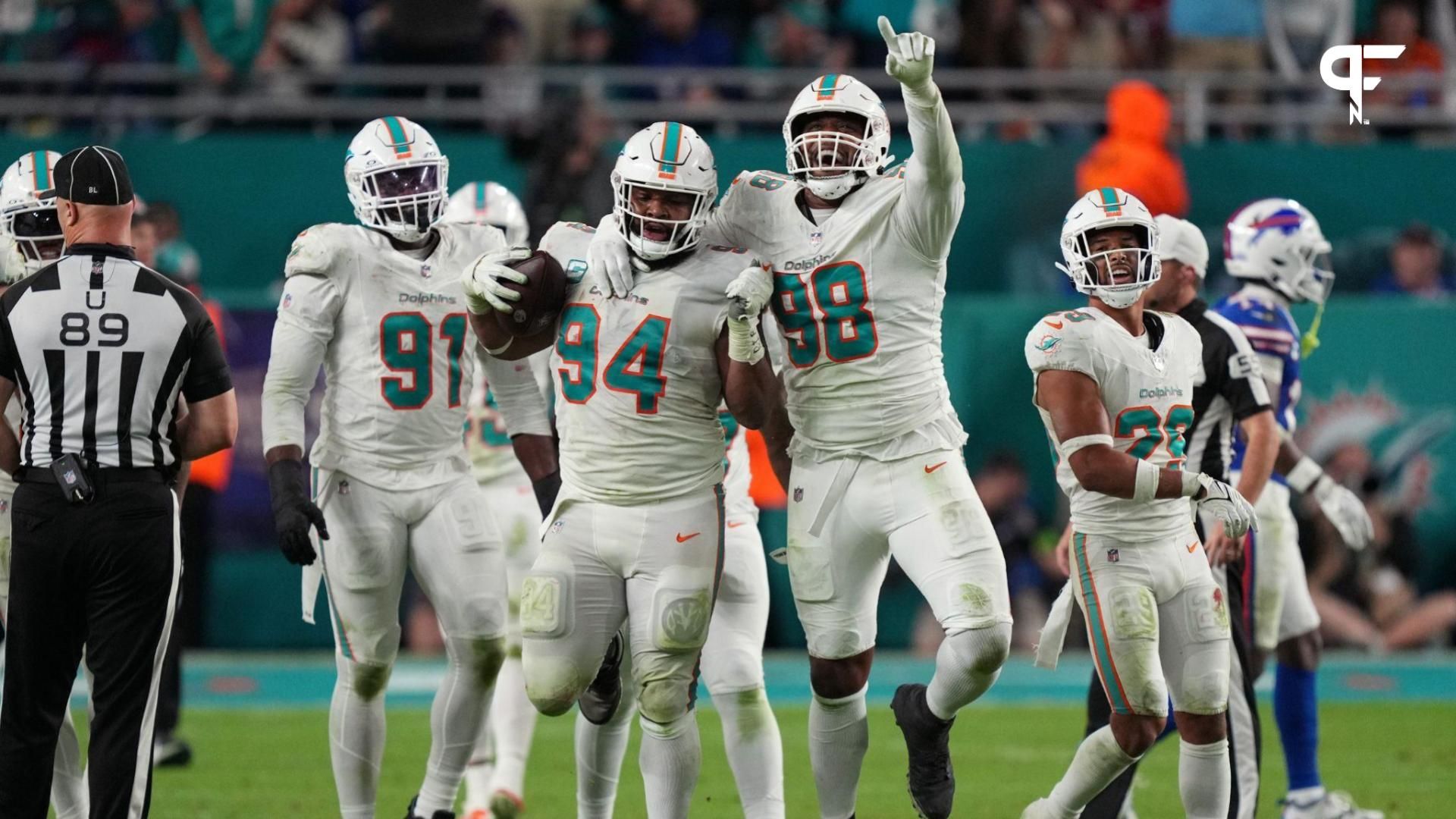 Miami Dolphins defensive tackle Christian Wilkins (94) celebrates a fumble recovery against the Buffalo Bills with teammate defensive tackle Raekwon Davis (98) during the second half at Hard Rock Stadium.