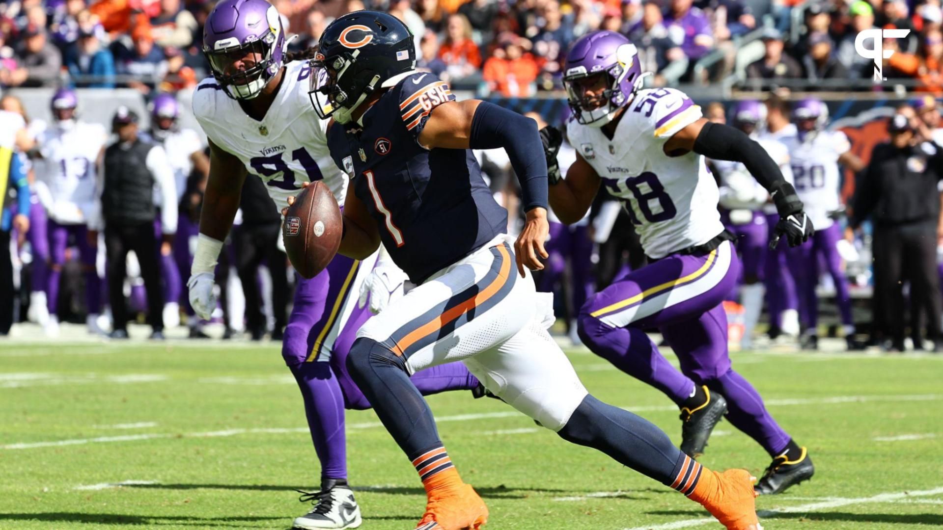 Chicago Bears quarterback Justin Fields (1) runs the ball past Minnesota Vikings linebacker Pat Jones II (91) during the first half at Soldier Field.