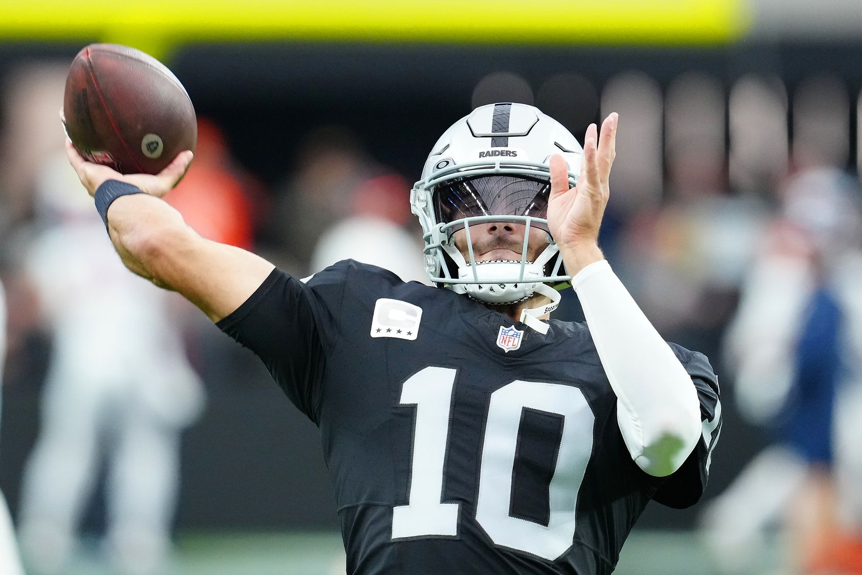 Las Vegas Raiders quarterback Jimmy Garoppolo (10) warms up before a game against the Denver Broncos at Allegiant Stadium.