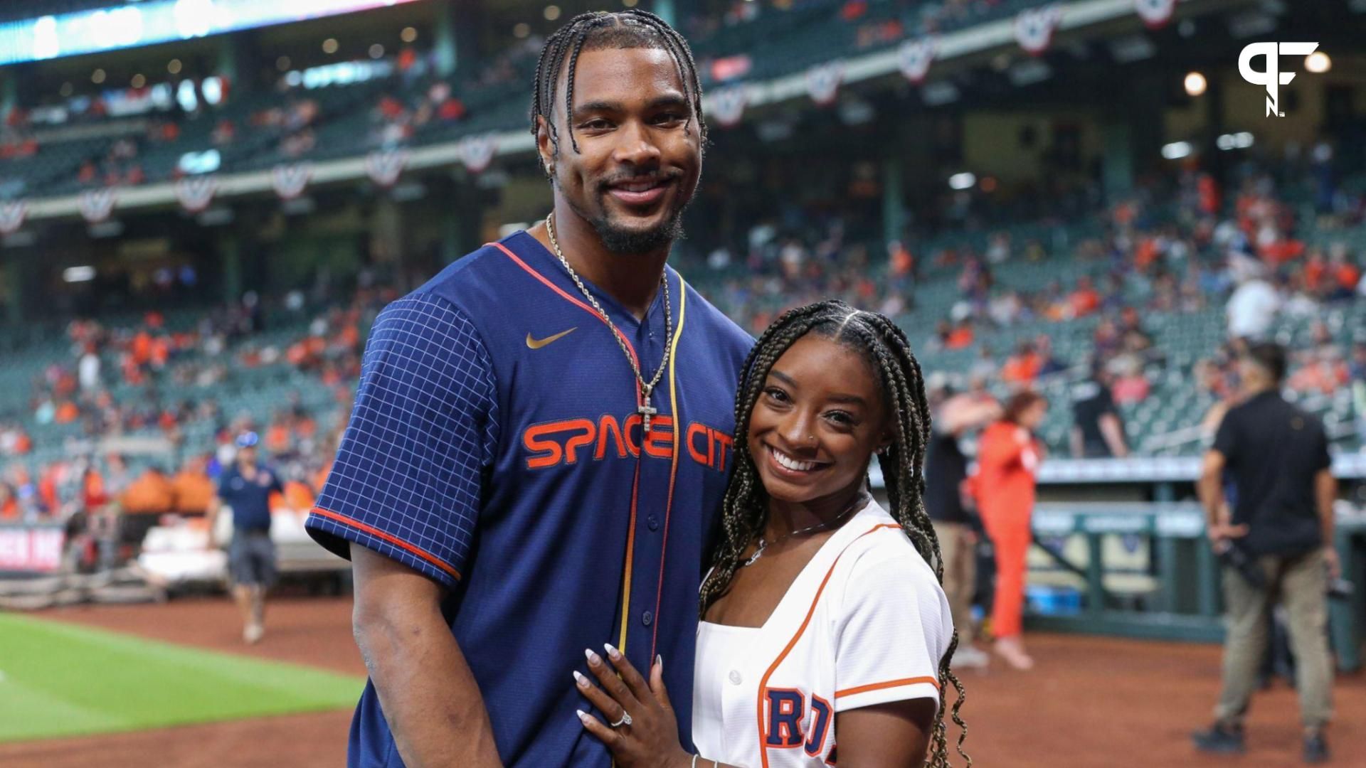 Olympic gold medalist gymnast Simone Biles and Houston Texans defensive back Jonathan Owens pose for a picture before the game between the Houston Astros and the Los Angeles Angels at Minute Maid Park.