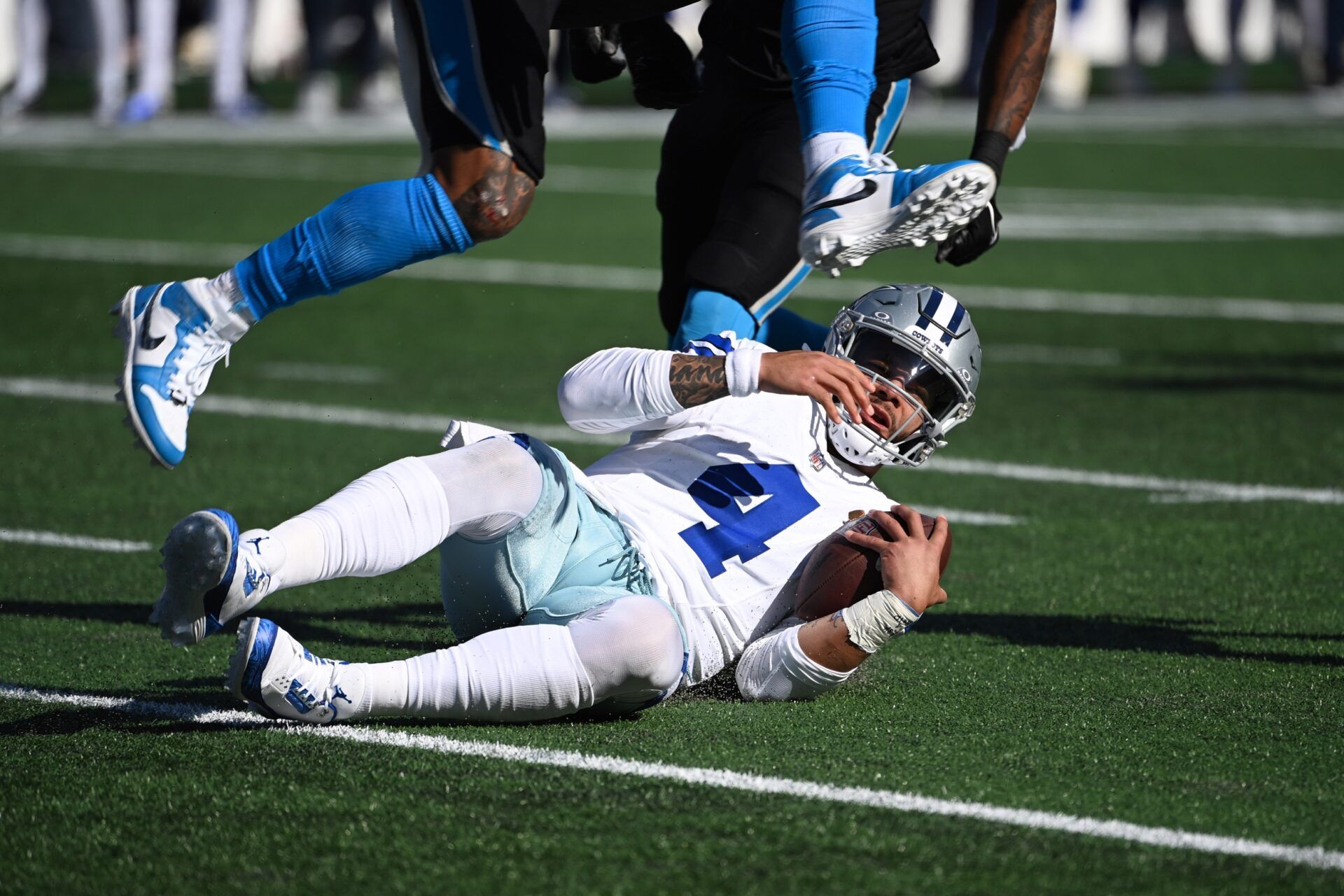 Dallas Cowboys quarterback Dak Prescott (4) slides in the second quarter at Bank of America Stadium.