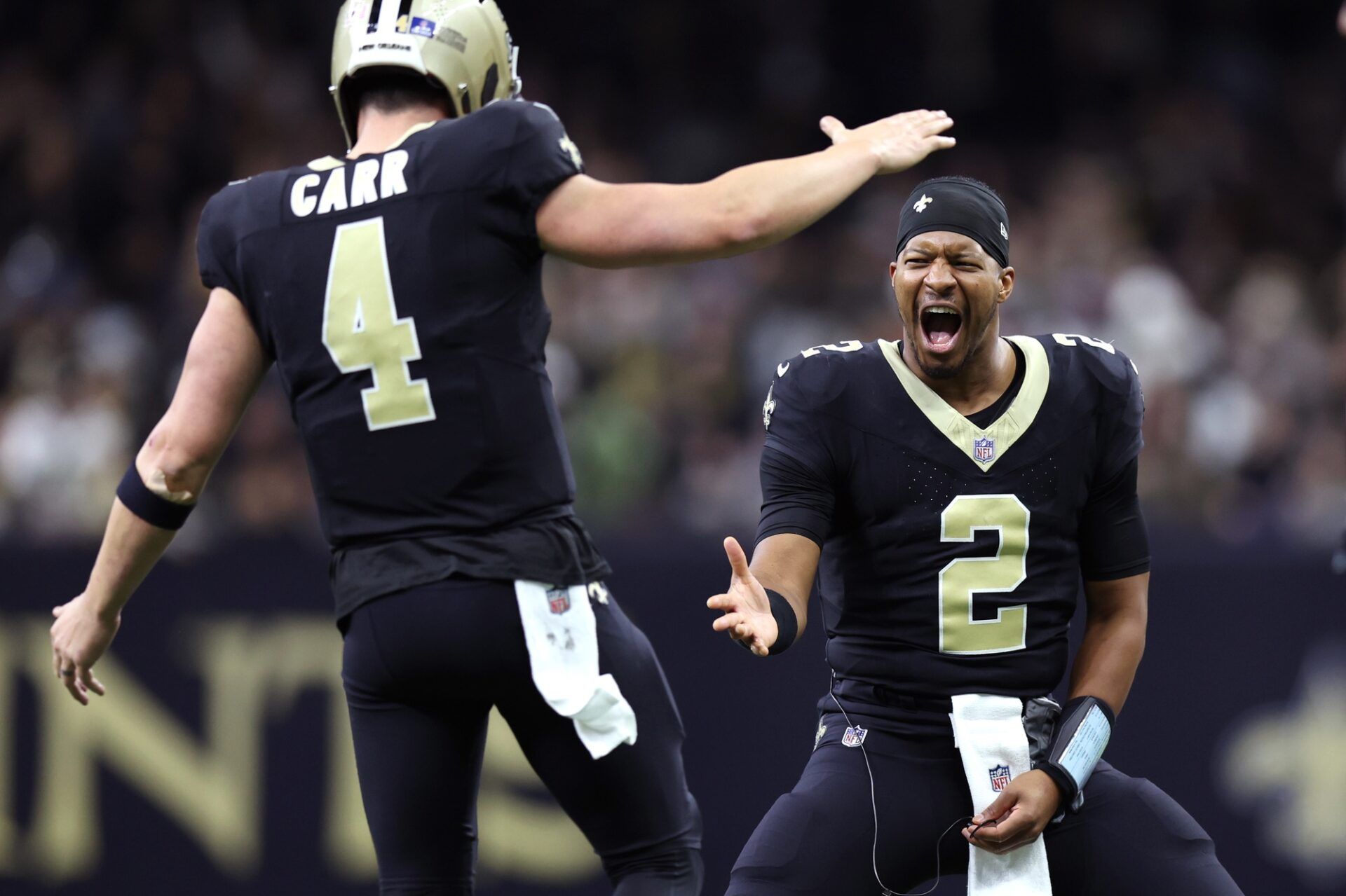 New Orleans Saints quarterback Derek Carr (4) is congratulated by quarterback Jameis Winston (2) after a touchdown against the New York Giants during the second half at Caesars Superdome.