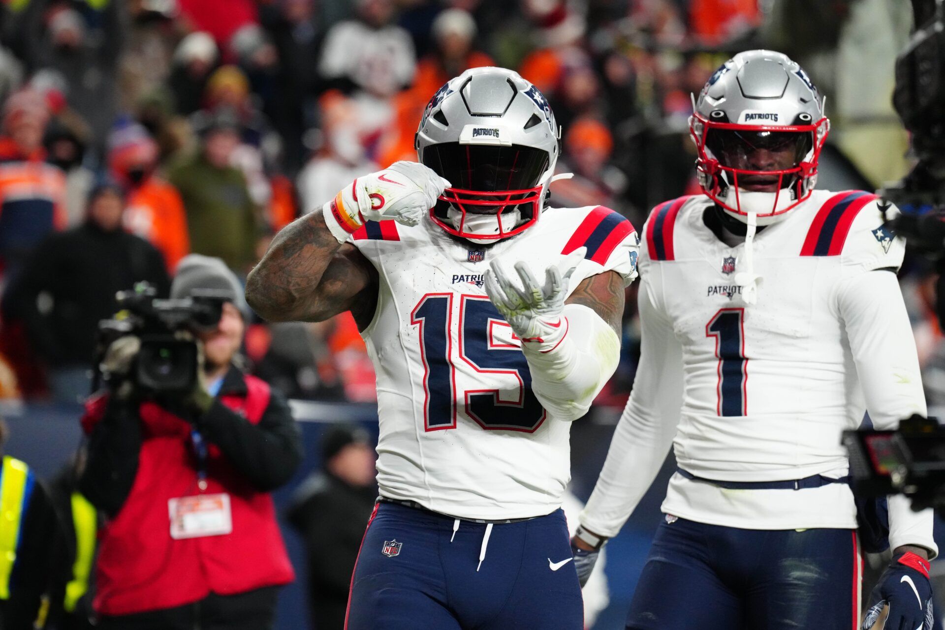 New England Patriots running back Ezekiel Elliott (15) celebrates scoring a touchdown in the third quarter against the Denver Broncos at Empower Field at Mile High.