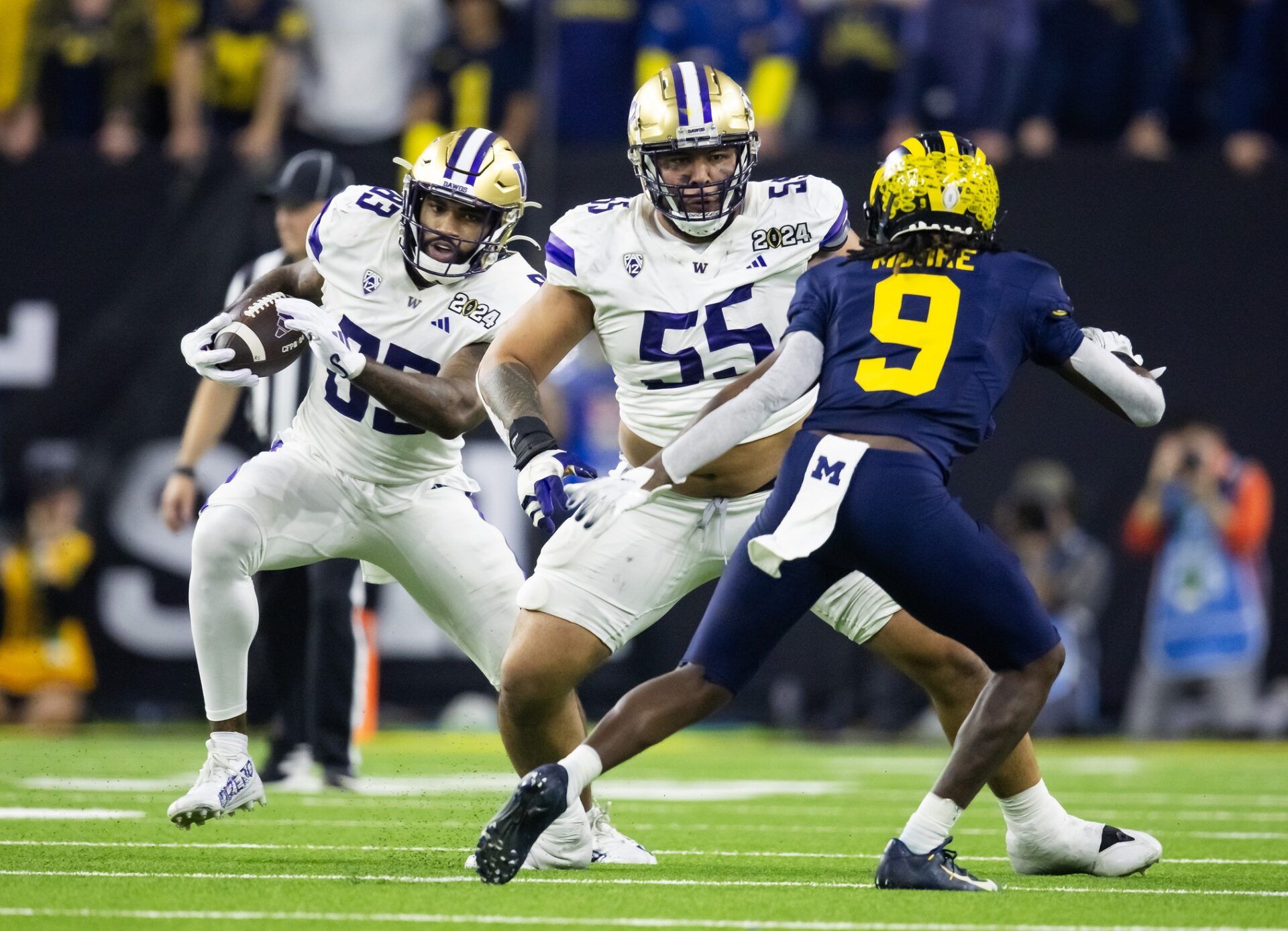 Washington Huskies offensive lineman Troy Fautanu (55) blocks for tight end Devin Culp (83) against the Michigan Wolverines during the 2024 College Football Playoff national championship game at NRG Stadium.