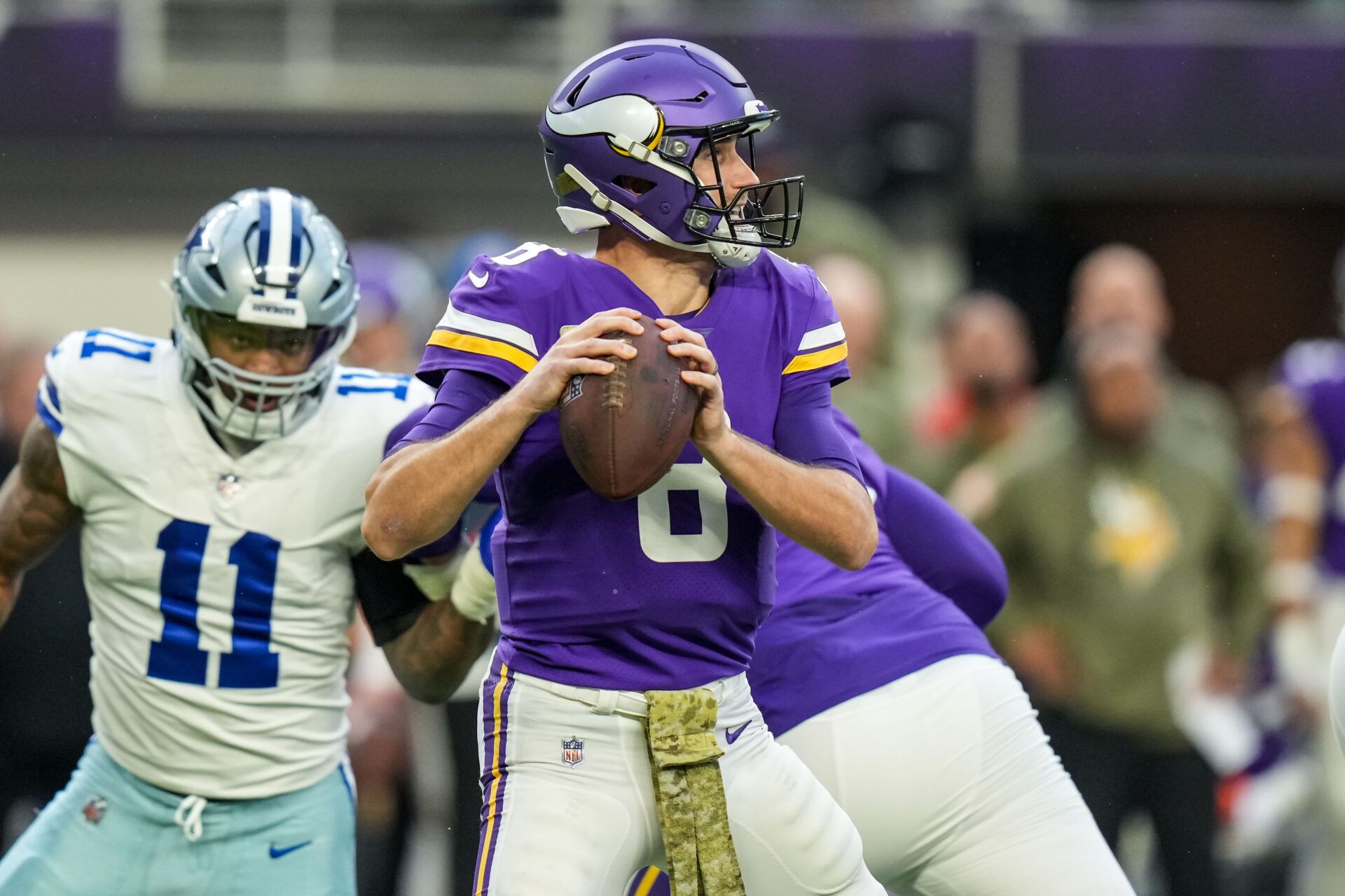 Minnesota Vikings quarterback Kirk Cousins (8) drops back to pass during the first quarter against the Dallas Cowboys at U.S. Bank Stadium.