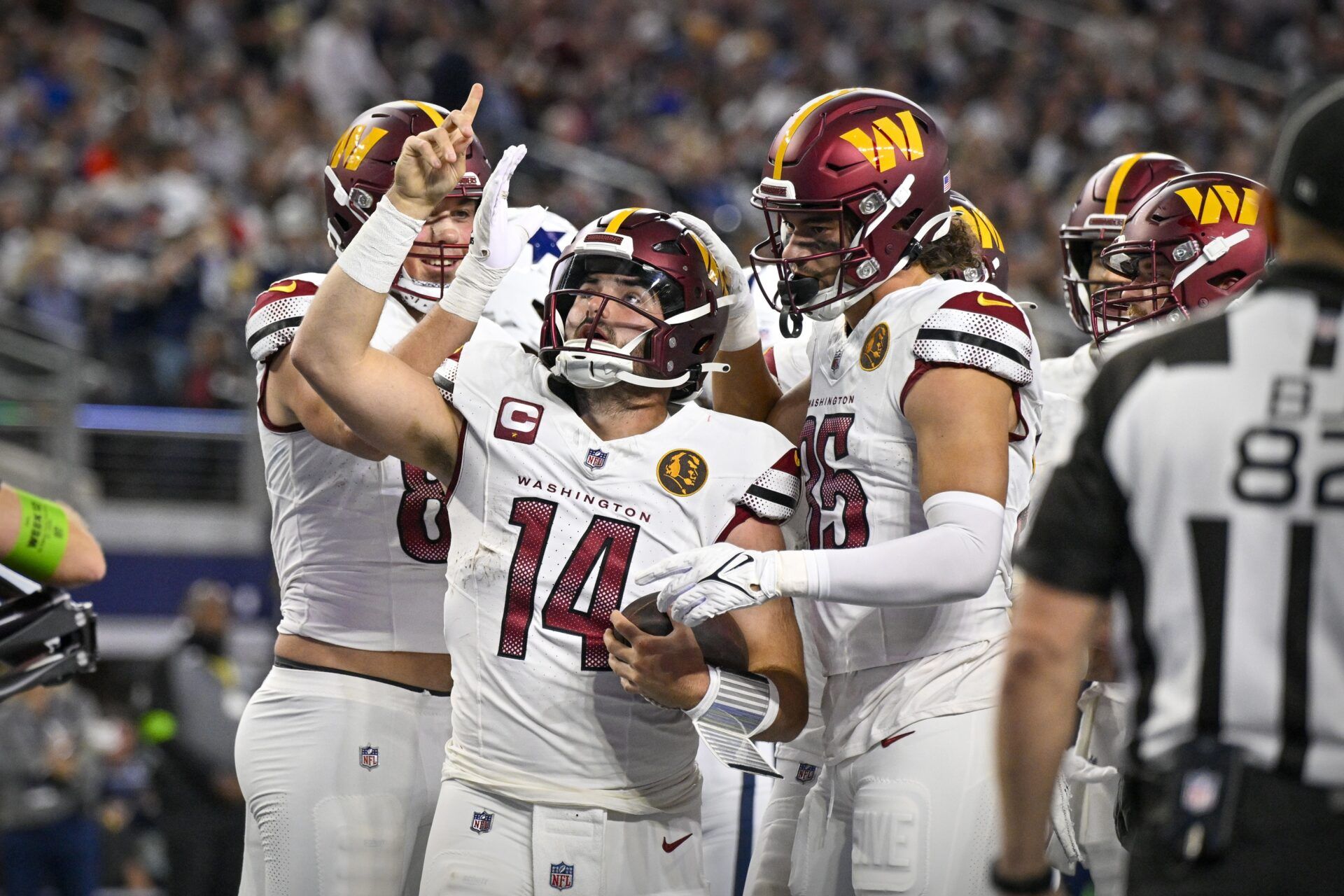 Washington Commanders quarterback Sam Howell (14) celebrates after he rushes for a touchdown against the Dallas Cowboys during the second quarter at AT&T Stadium.