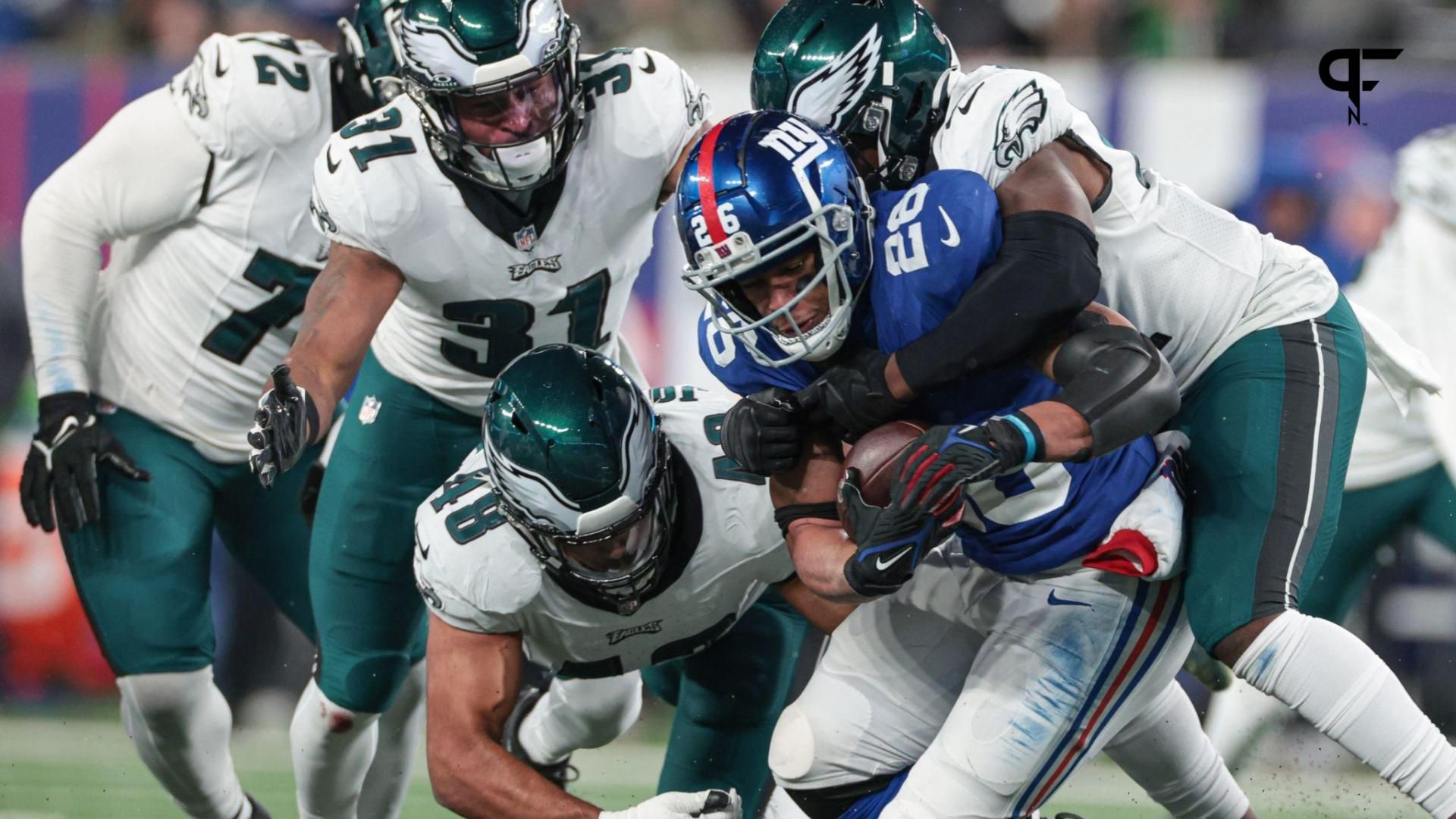 New York Giants running back Saquon Barkley (26) is tackled by Philadelphia Eagles linebacker Nicholas Morrow (41) and linebacker Patrick Johnson (48) and safety Kevin Byard (31) during the second half at MetLife Stadium.