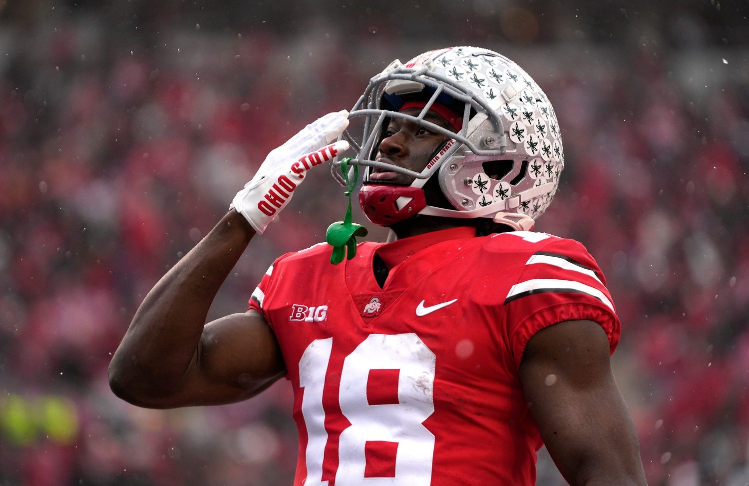 Ohio State Buckeyes WR Marvin Harrison Jr. (18) gestures towards the crowd.