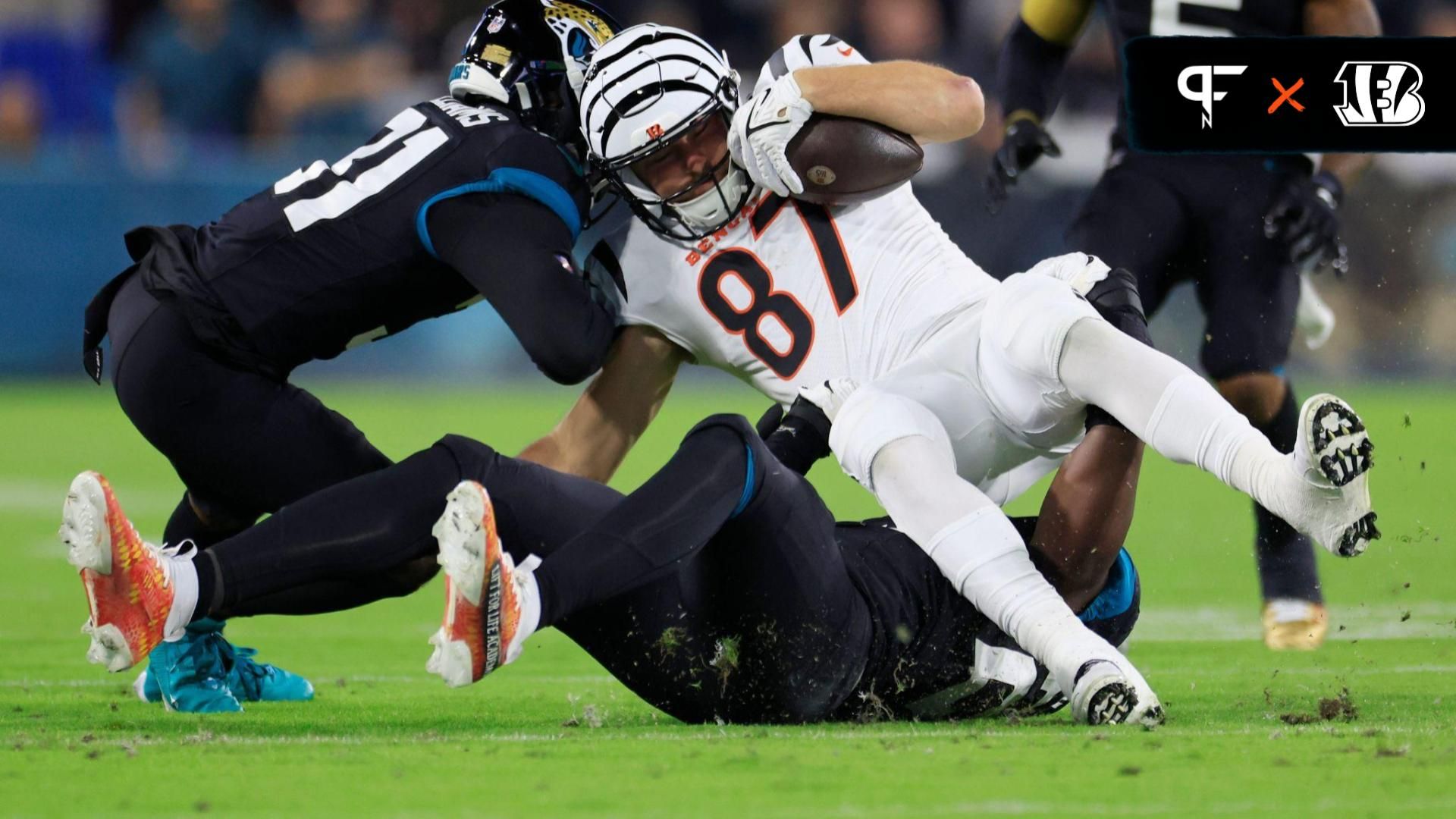 Cincinnati Bengals tight end Tanner Hudson (87) is tackled by Jacksonville Jaguars cornerback Darious Williams (31), left, and linebacker Foyesade Oluokun (23), bottom, during the first quarter of a regular season NFL football matchup Monday, Dec. 4, 2023 at EverBank Stadium in Jacksonville, Fla. The Cincinnati Bengals defeated the Jacksonville Jaguars 34-31 in overtime.