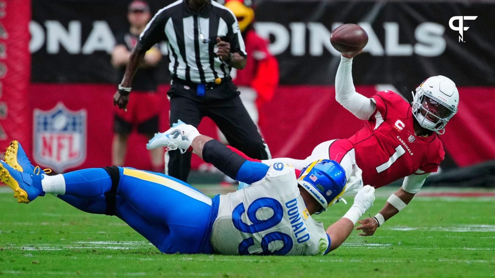 Rams Aaron Donald (99) attempts to sack Cardinals quarterback Kyler Murray (1) as he gets off a pass just before going down during the first half at State Farm Stadium.