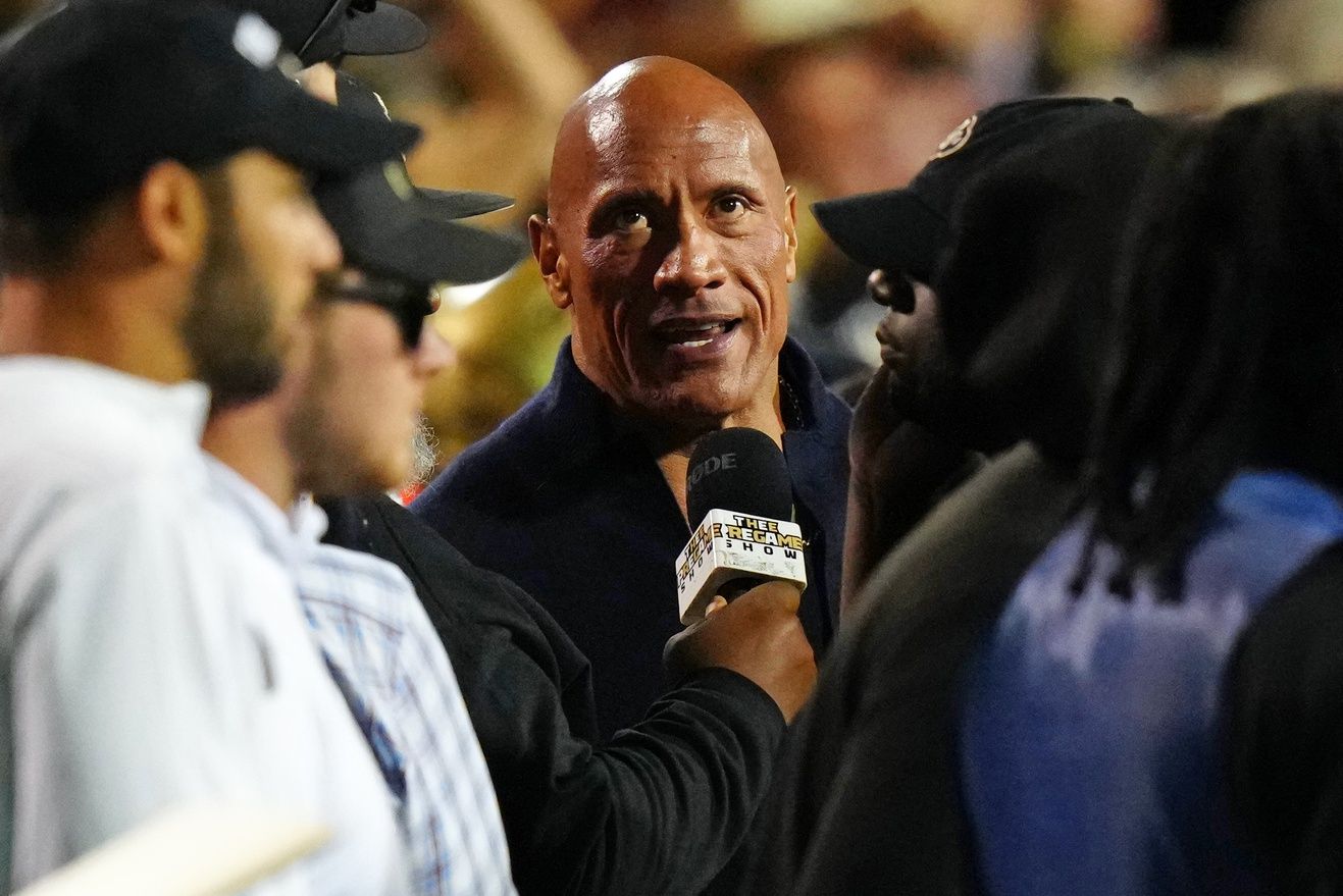 One of the UFL's owners, The Rock is interviewed on the sideline in the second quarter of the game between the Colorado Buffaloes and the Colorado State Rams at Folsom Field.