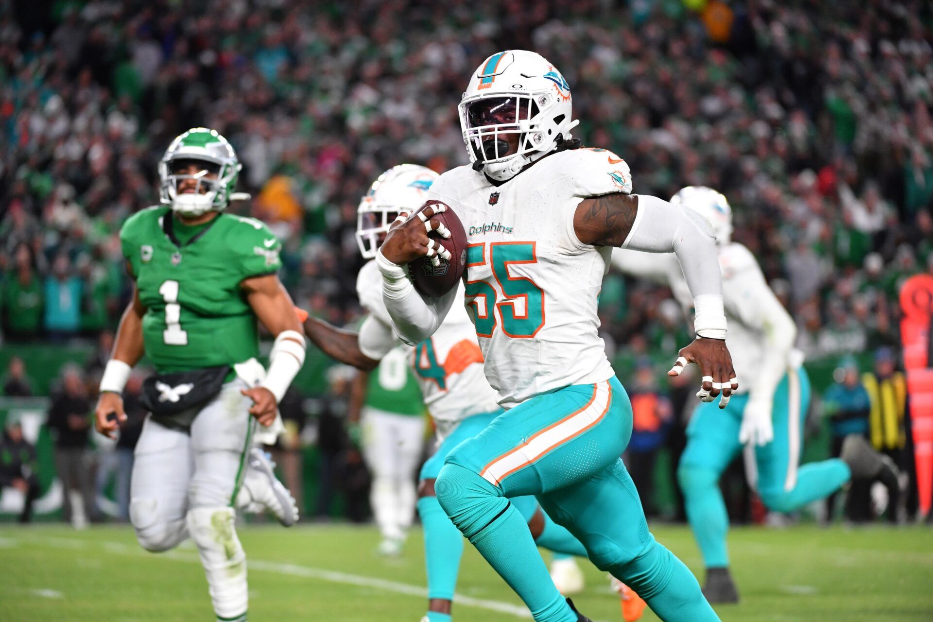 Miami Dolphins linebacker Jerome Baker (55) returns an interception for a touchdown during the third quarter against the Philadelphia Eagles at Lincoln Financial Field.