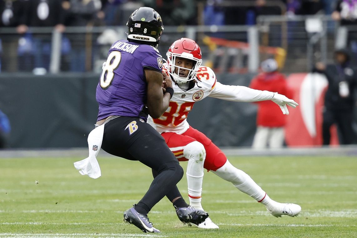 Kansas City Chiefs DB L'Jarius Sneed (38) attempts to tackle Baltimore Ravens QB Lamar Jackson (8).