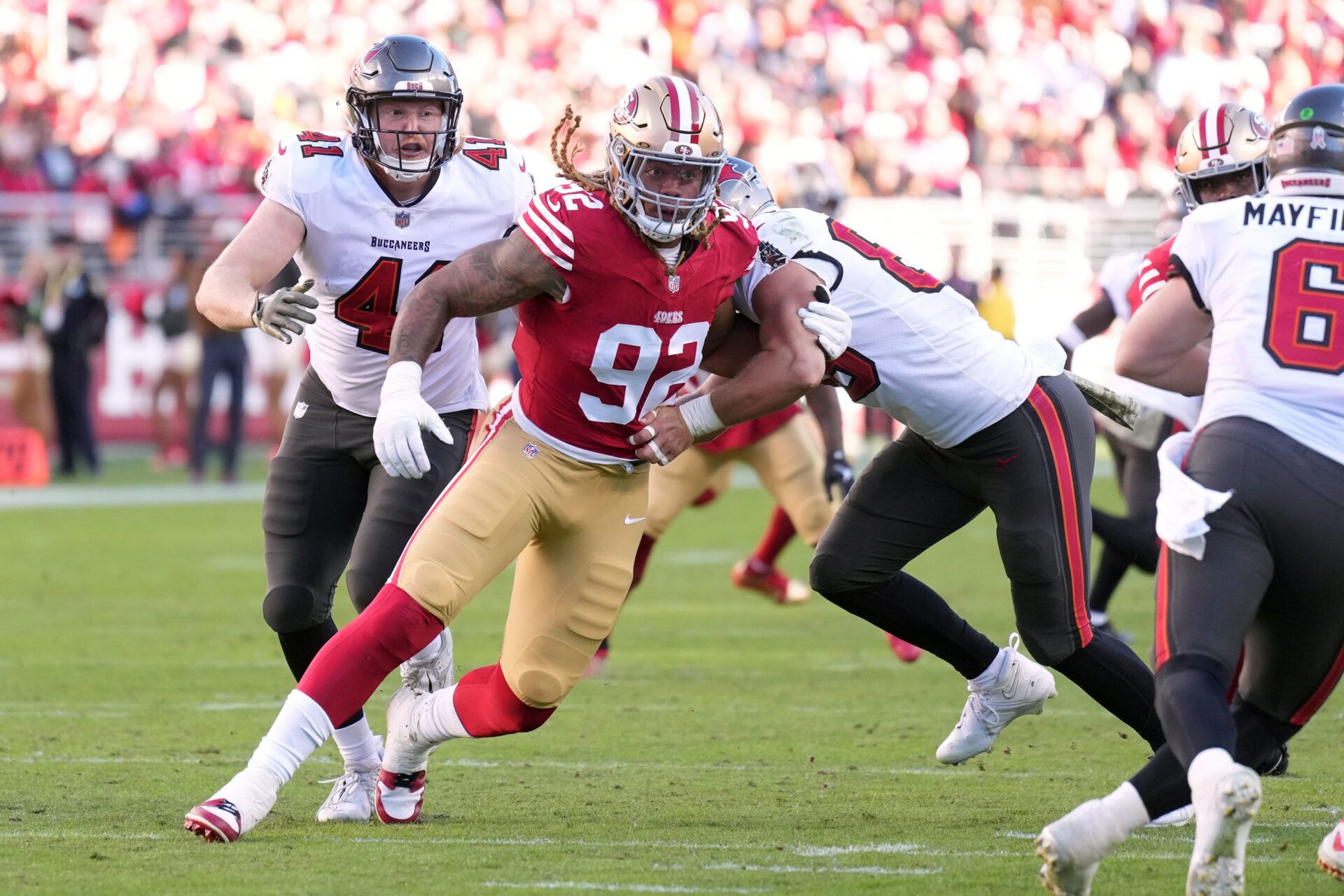 San Francisco 49ers defensive end Chase Young (92) rushes against Tampa Bay Buccaneers tight end Cade Otton (right) during the third quarter at Levi's Stadium.